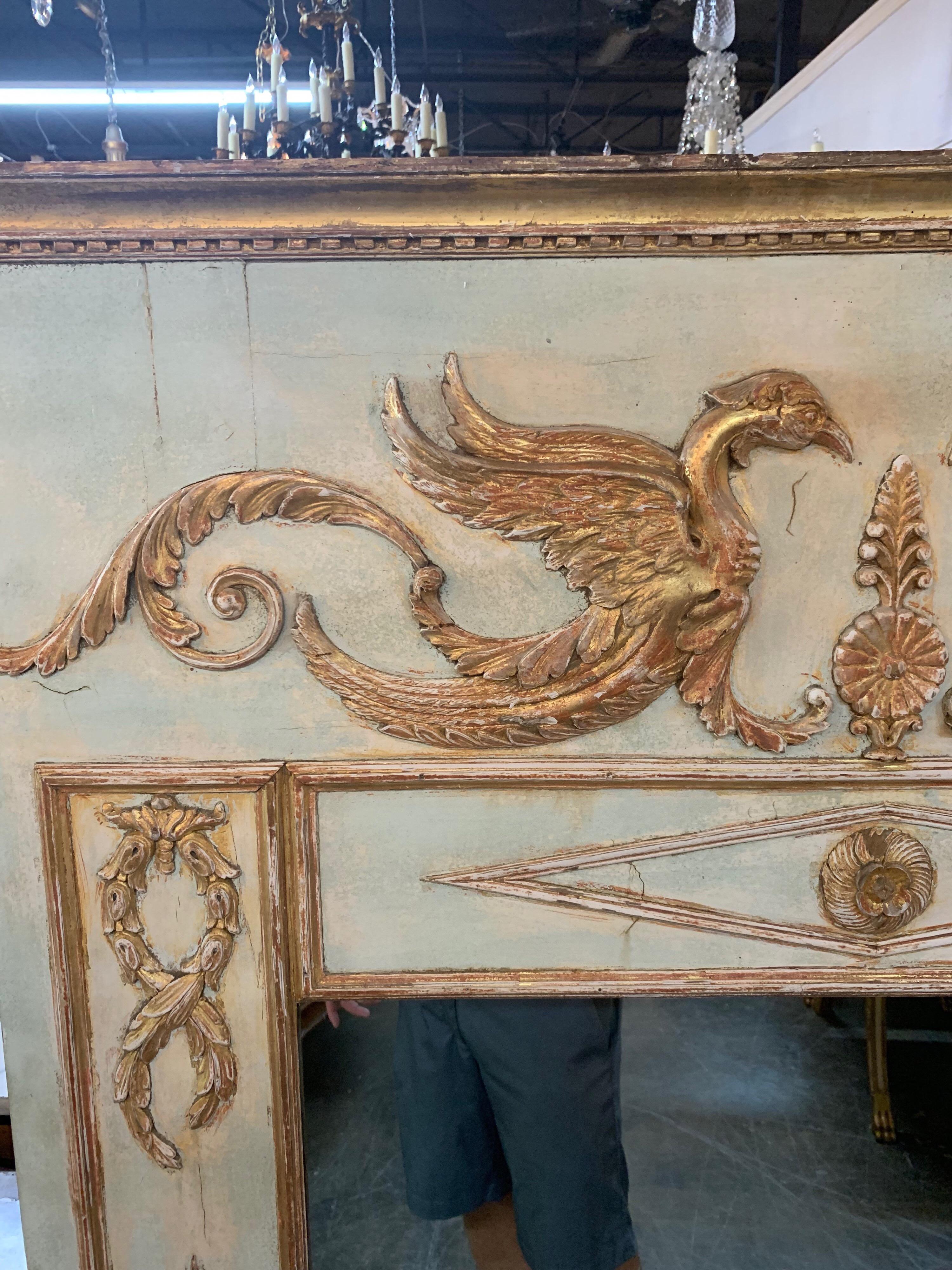 Early 19th century French Empire neoclassical carved and parcel gilt trumeau mirror.
Very interested carving of 2 dragons and other leaves, scrolls and diamonds. Nice patina on the piece as well. Very impressive!