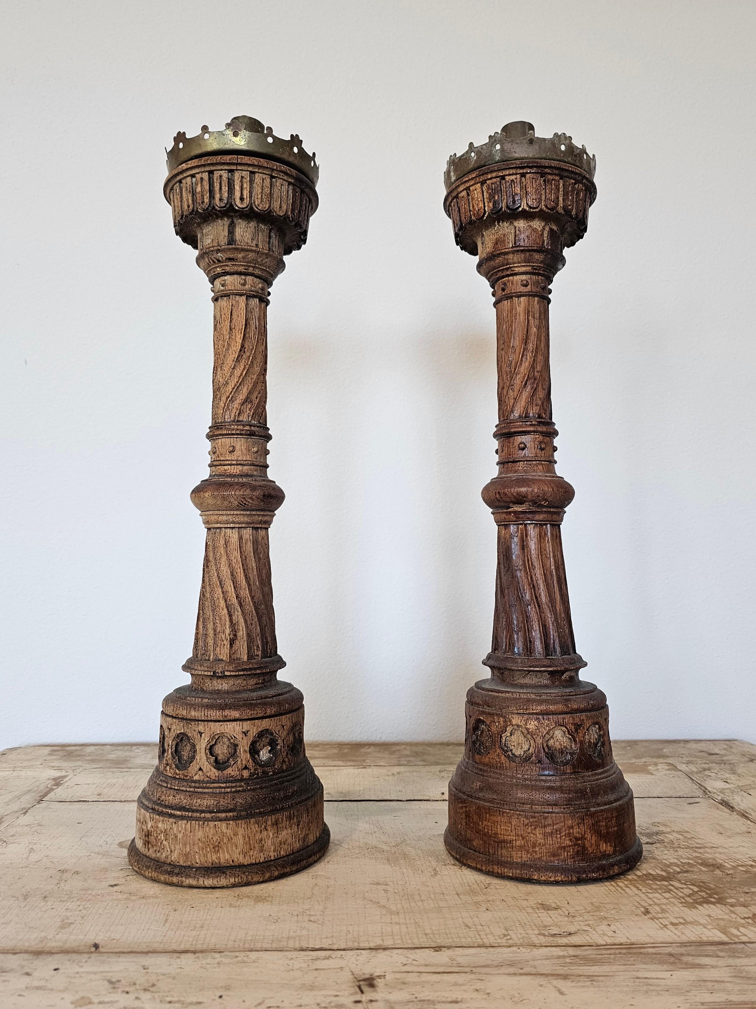 A remarkable pair antique French Gothic Revival ecclesiastical hand carved wood church altar sticks. 

19th Century, France, exceptionally executed, mounted with a brass nozzle / candleholder tube, with removable brass crown pricket drip pan, over