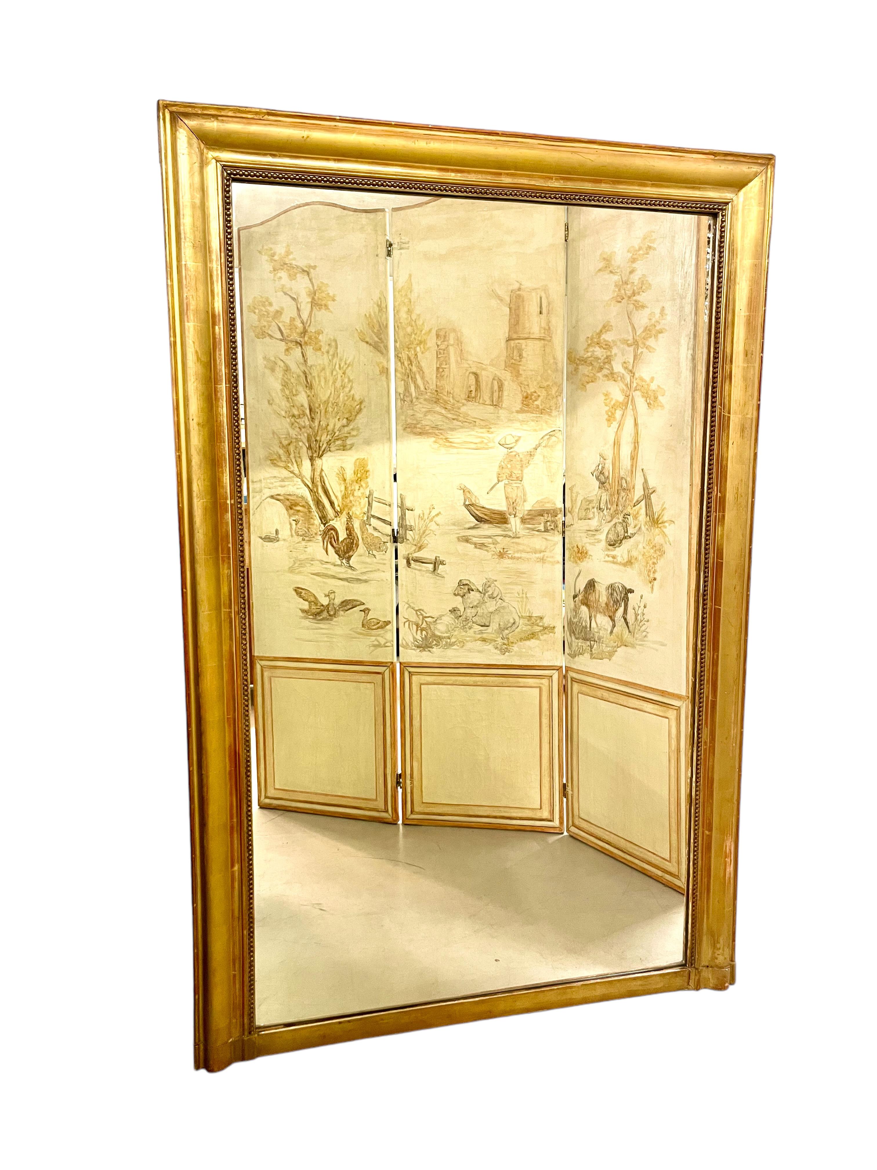 An imposing French 19th century trumeau mirror in wood and gilded stucco, crafted in a neo- classical style. This simple but elegant mirror is enclosed within a fluted giltwood frame, its inner rim edged with a classic 'string of pearls' motif to