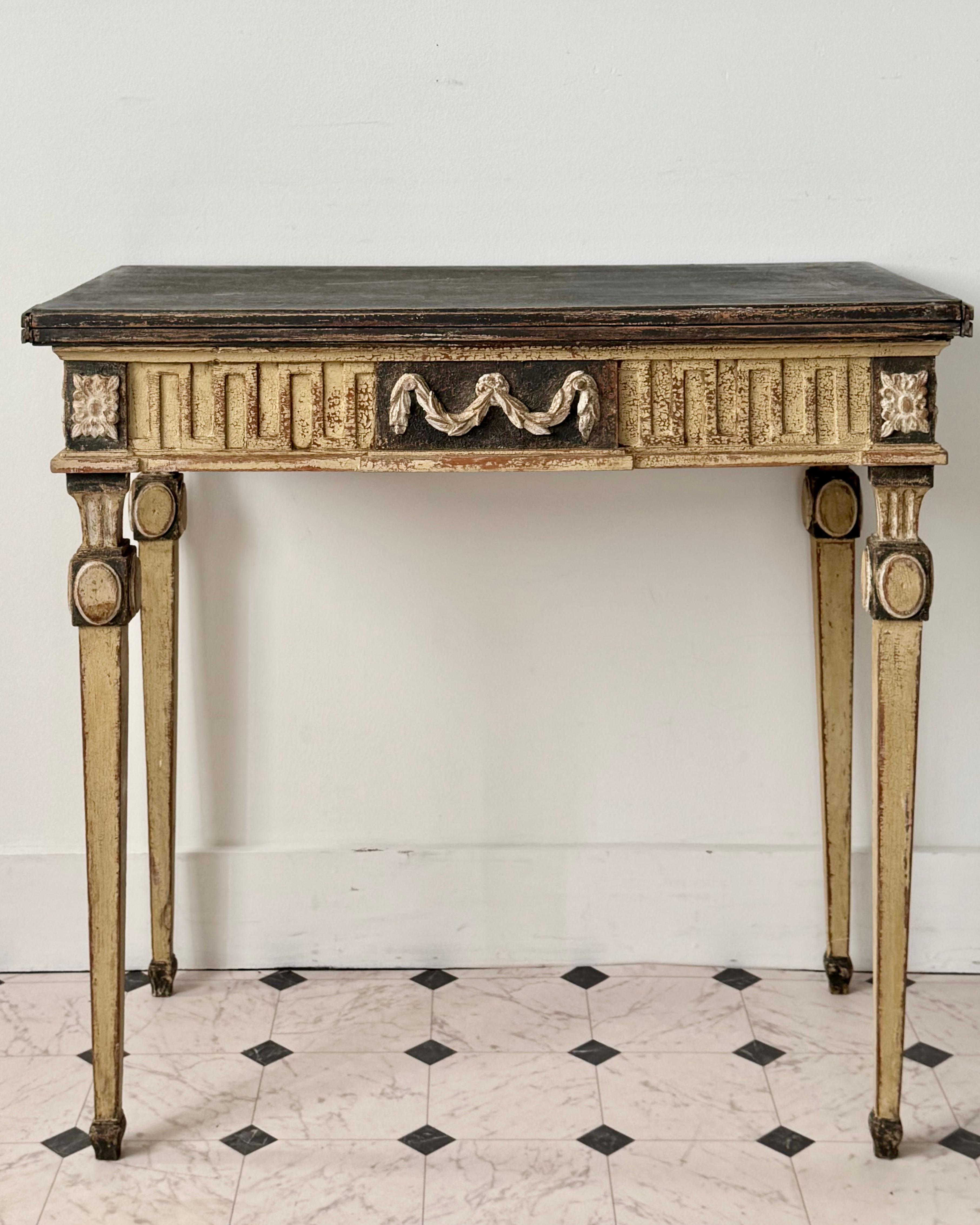  Early 19th century French neoclassical console table crafted with meticulous attention to detail, finely carved all sides wooden frame, adorned with classical motifs. The console table top swivels and opens to the square shape 33.50
