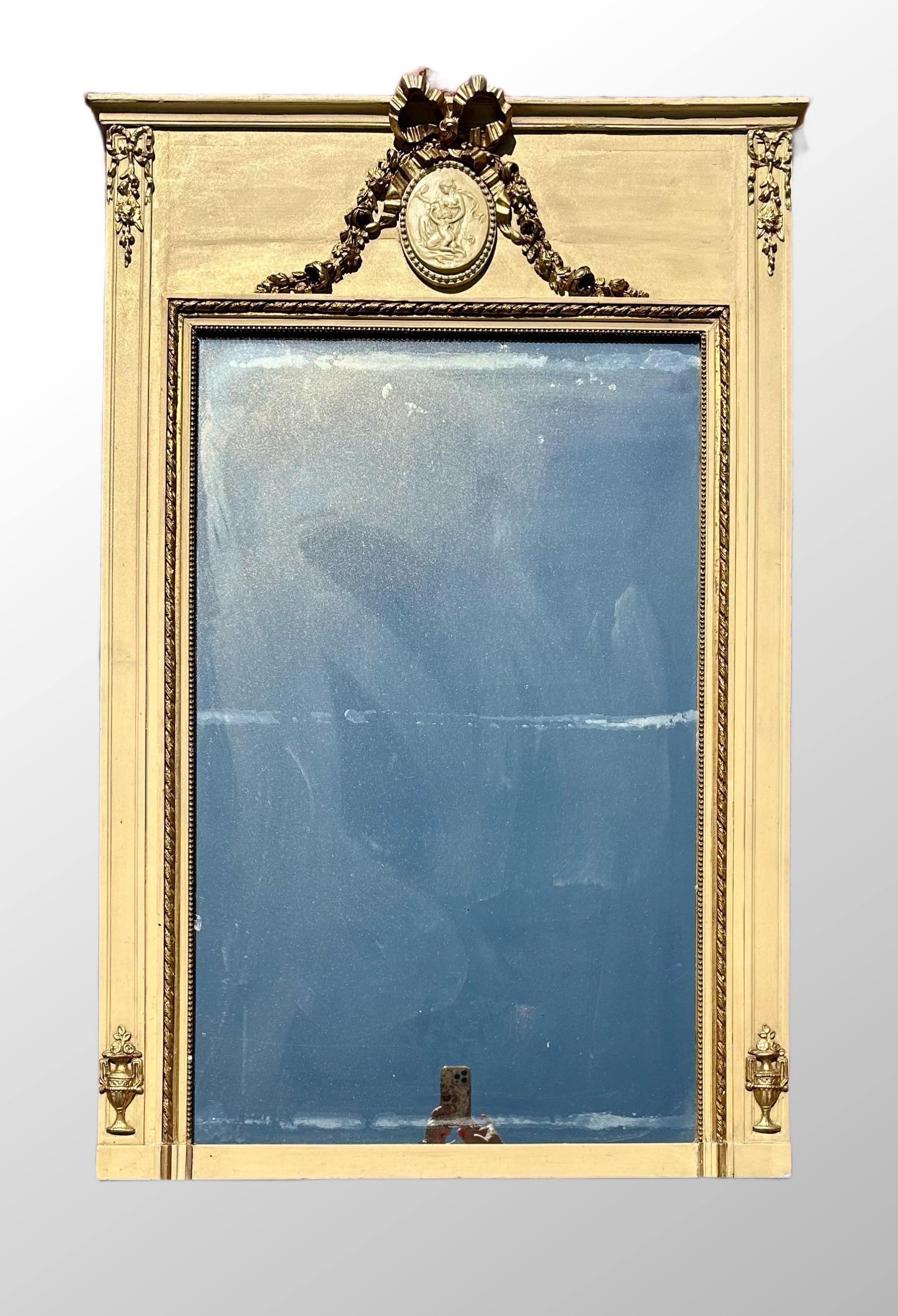 19th Century French Neoclassical Painted Trumeau ca. 1870.

19th century Louis XV style elegant French Trumeau wall panel. The panel is a symmetrical, rectangular shape and features giltwood molding on a cream painted background. Classic