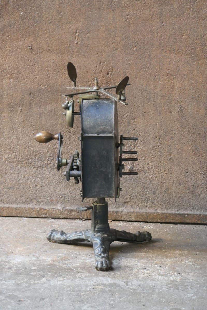 Functional and beautiful early 19th century French Neoclassical Period roasting jack made of cast iron, wrought iron and brass. It is used for cooking in a kitchen fireplace. It is in height adjustable. The condition is good.