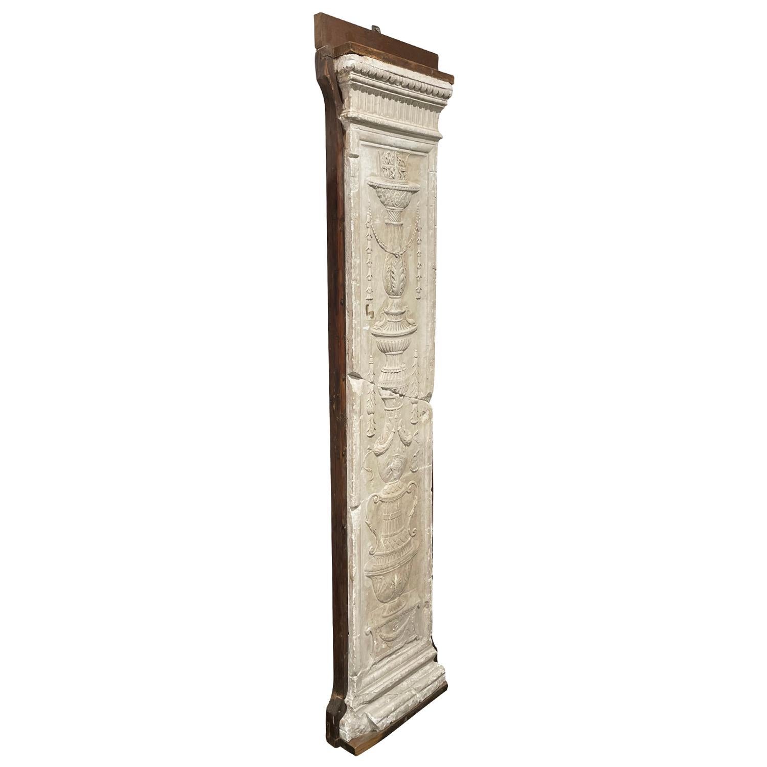 A white, antique French Neoclassical style pilaster made of hand crafted plaster mounted on Walnut board, in good condition. The detailed wall, bas relief represents the Neoclassicism and Classicism time period, era. Wear consistent with age and