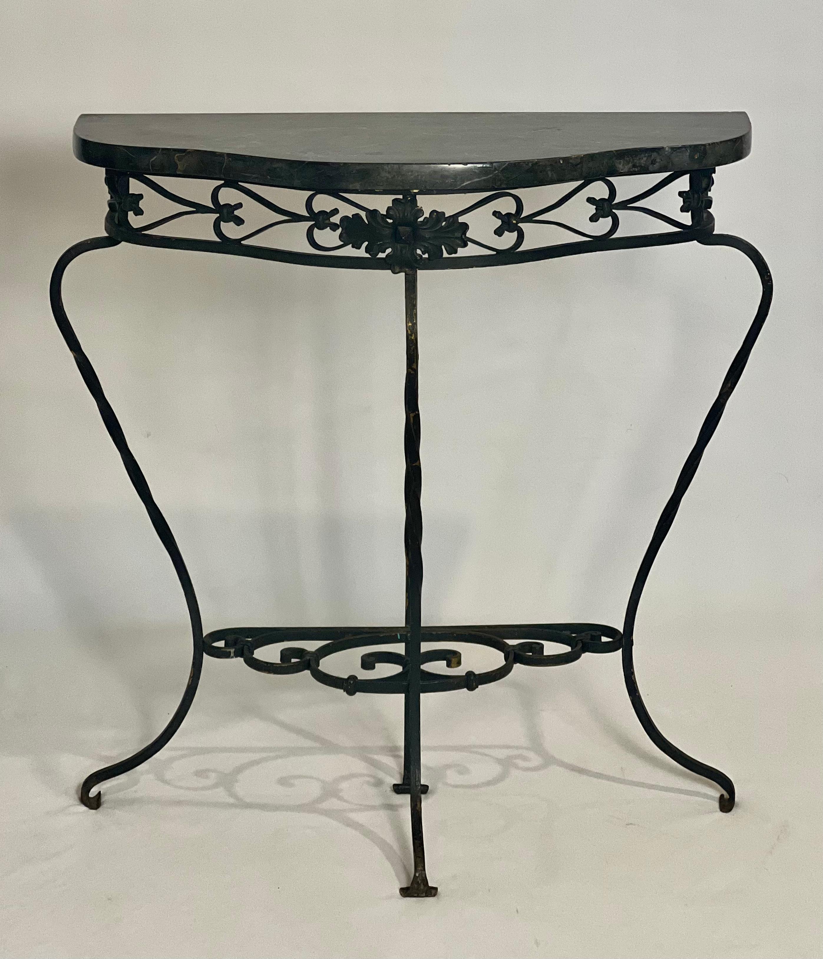 Fantastic Neoclassical style wrought iron and marble console, France, circa 1880-1900.

A lovely table adorned with elegant iron work including twisted cabriole legs, a central high-relief flower head and scroll detail possibly inspired by a Spanish