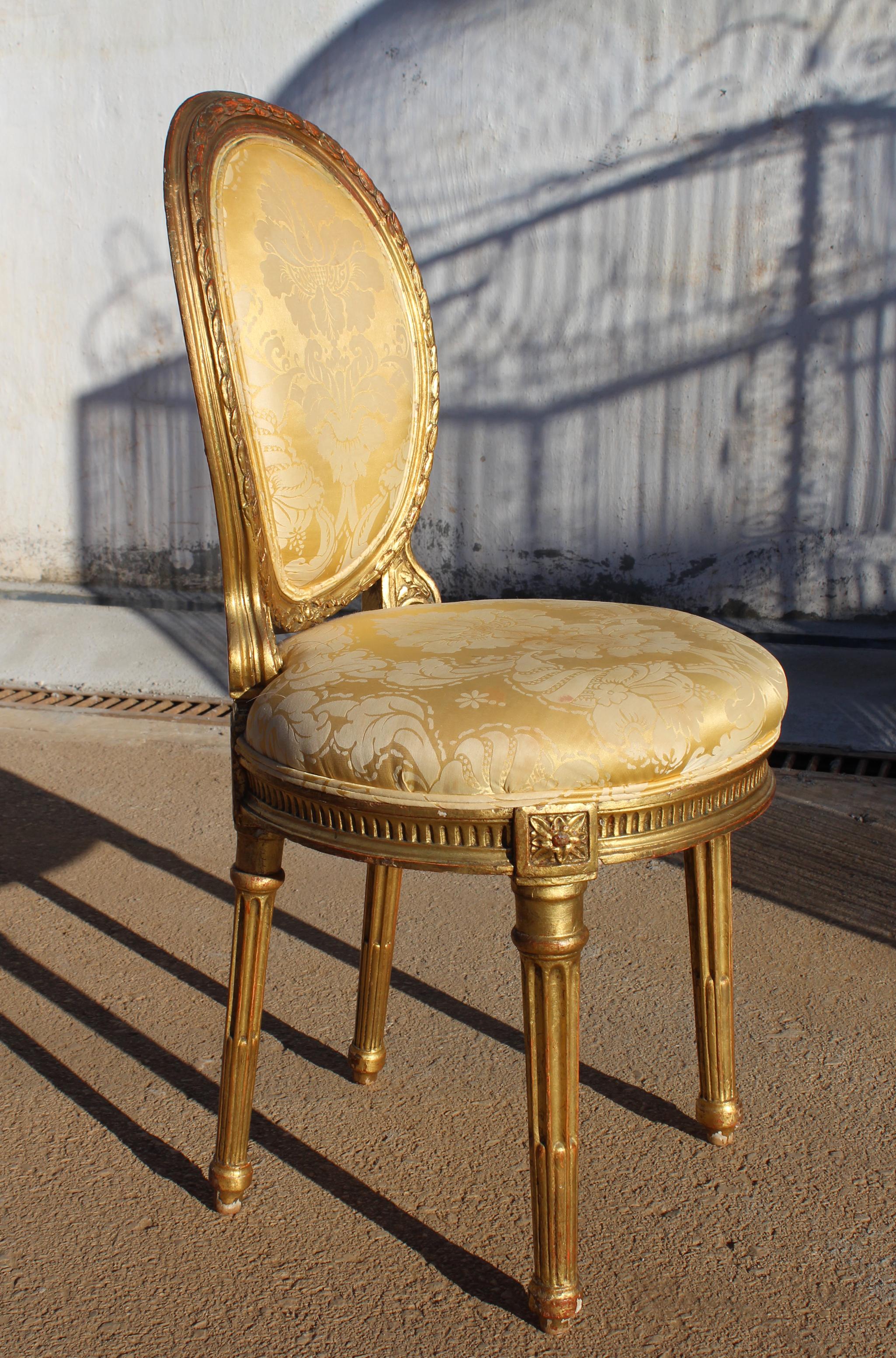 19th century French neoclassical upholstered chair, with the rare quality of being slightly smaller than similar period chairs, making it rare and unique.