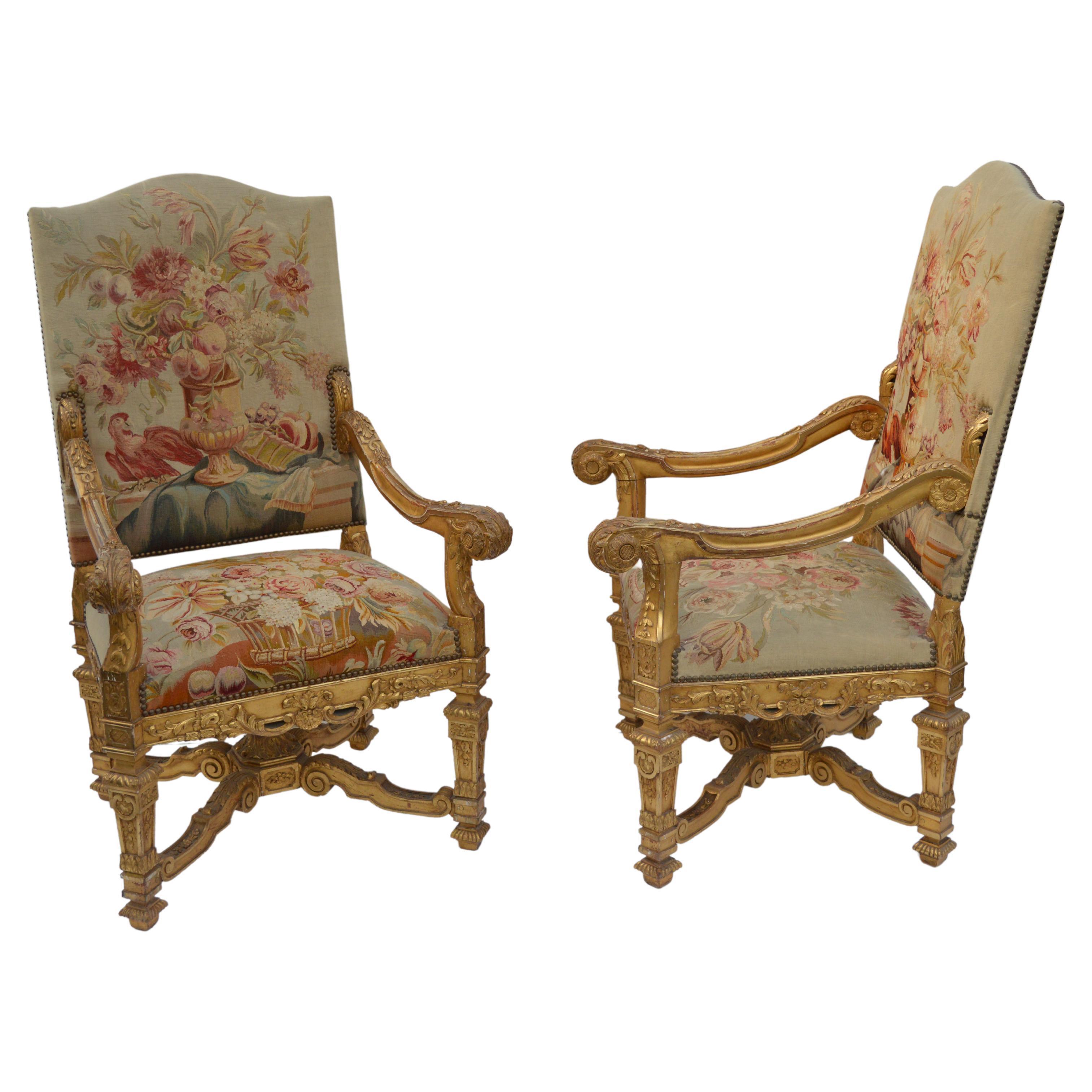 Pair of large late 19th century, French neoclassical water gilded, hand-carved walnut armchairs, with Tapestry upholstery.