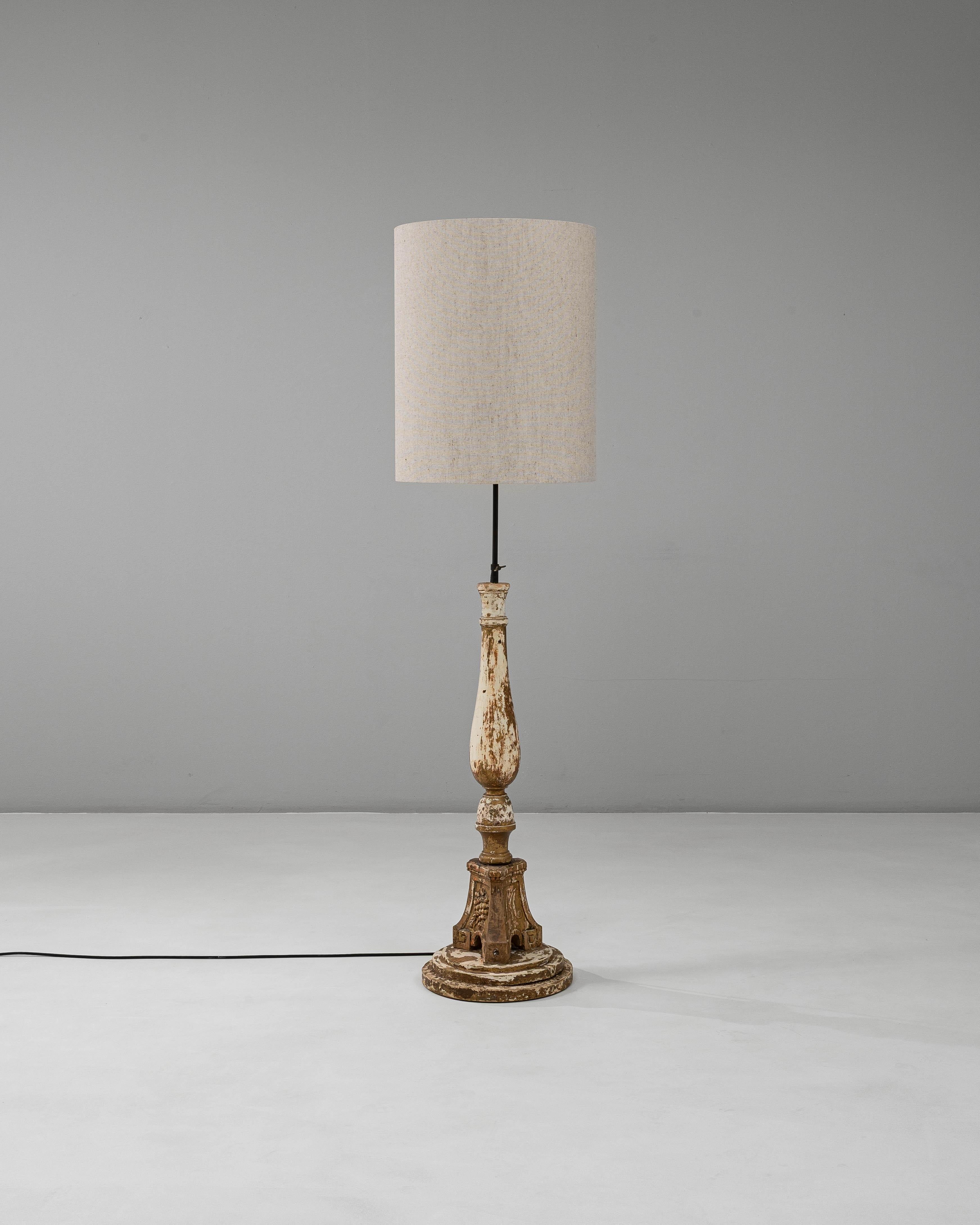 This 19th Century French Neoclassical Wood Patinated Floor Lamp beautifully merges classical ornamentation with timeless patina. Originally crafted as a carved wooden column, it has been expertly converted into a floor lamp while preserving its