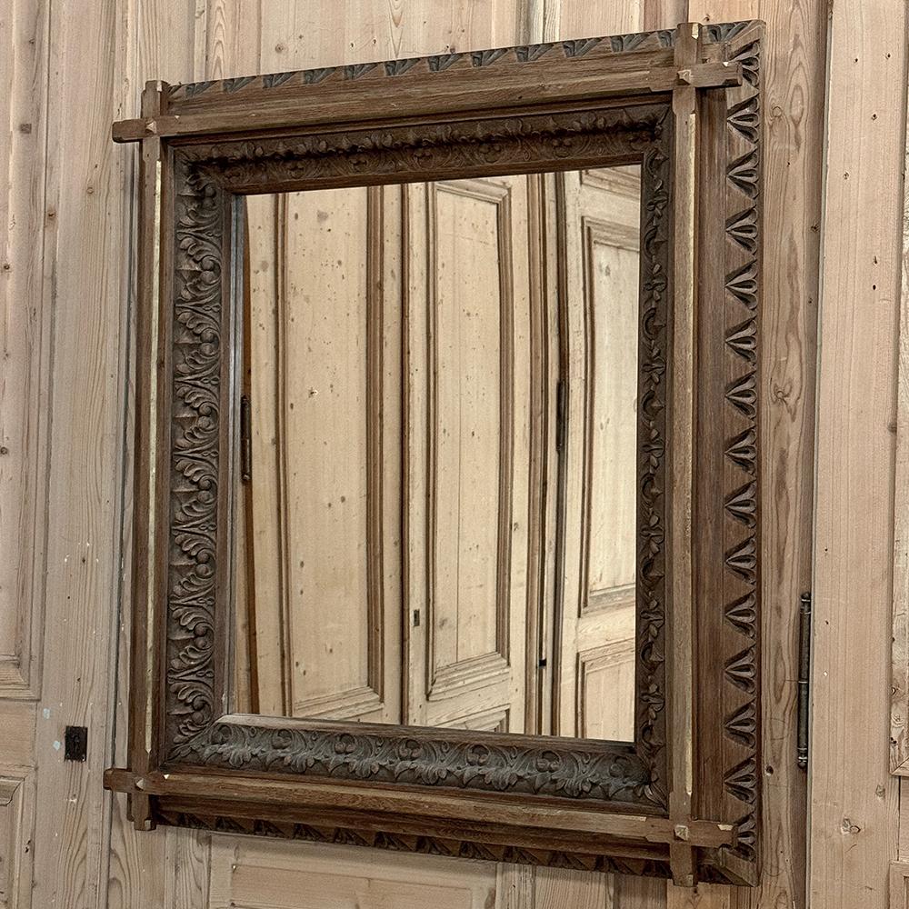 19th Century French Neogothic Oak Mirror was hand-crafted during the Arts & Crafts period, and features a sturdy, stoutly made framework with a stylized egg & dart trim carved all around the entire perimeter, with a raised mullion still showing just