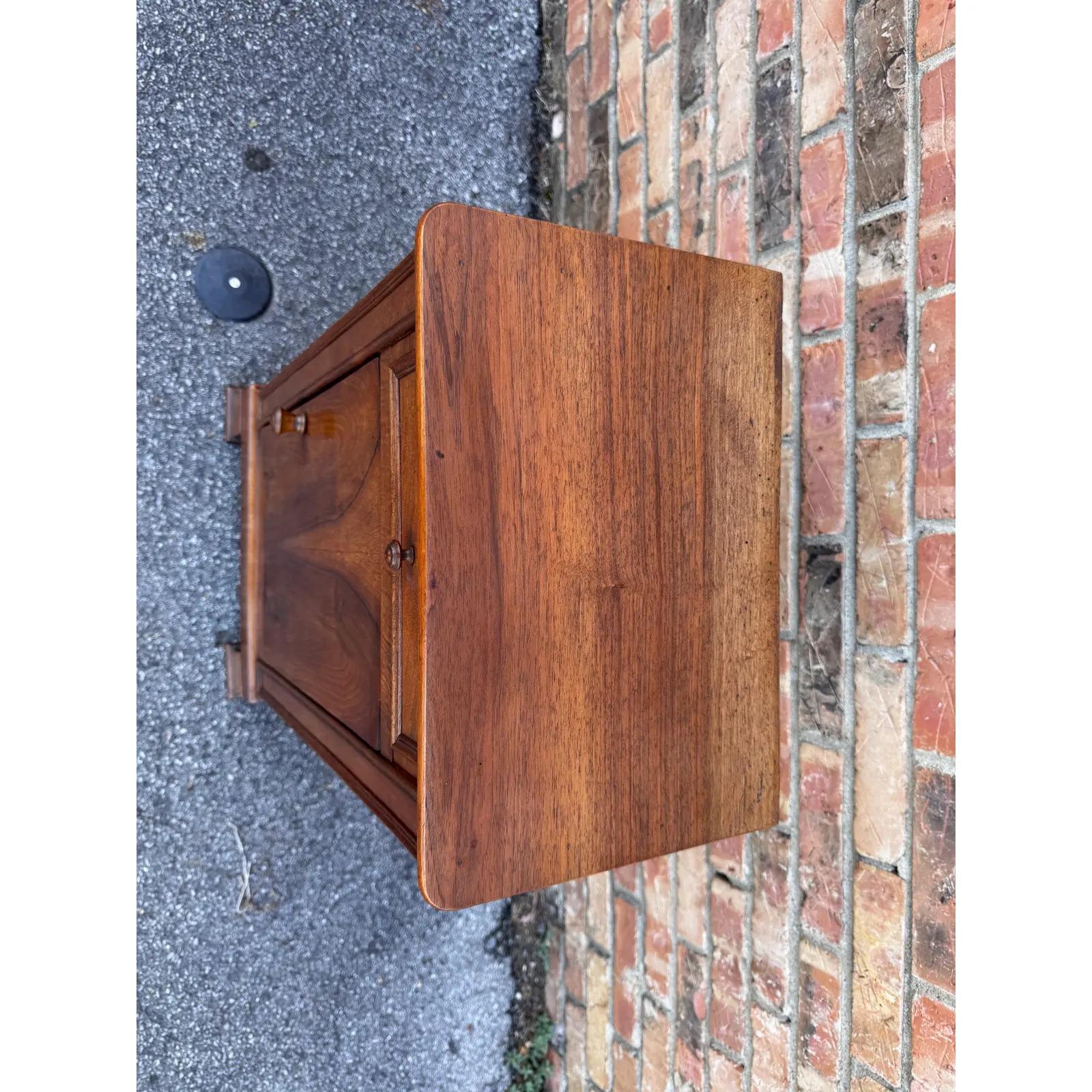 This is a beautiful little antique cabinet! Small and simple and yet so appealing, this piece dates to the 19th century and is of French make. The wood has a soft glow from its patina and the natural tone and detail of the wood shows up nicely. The