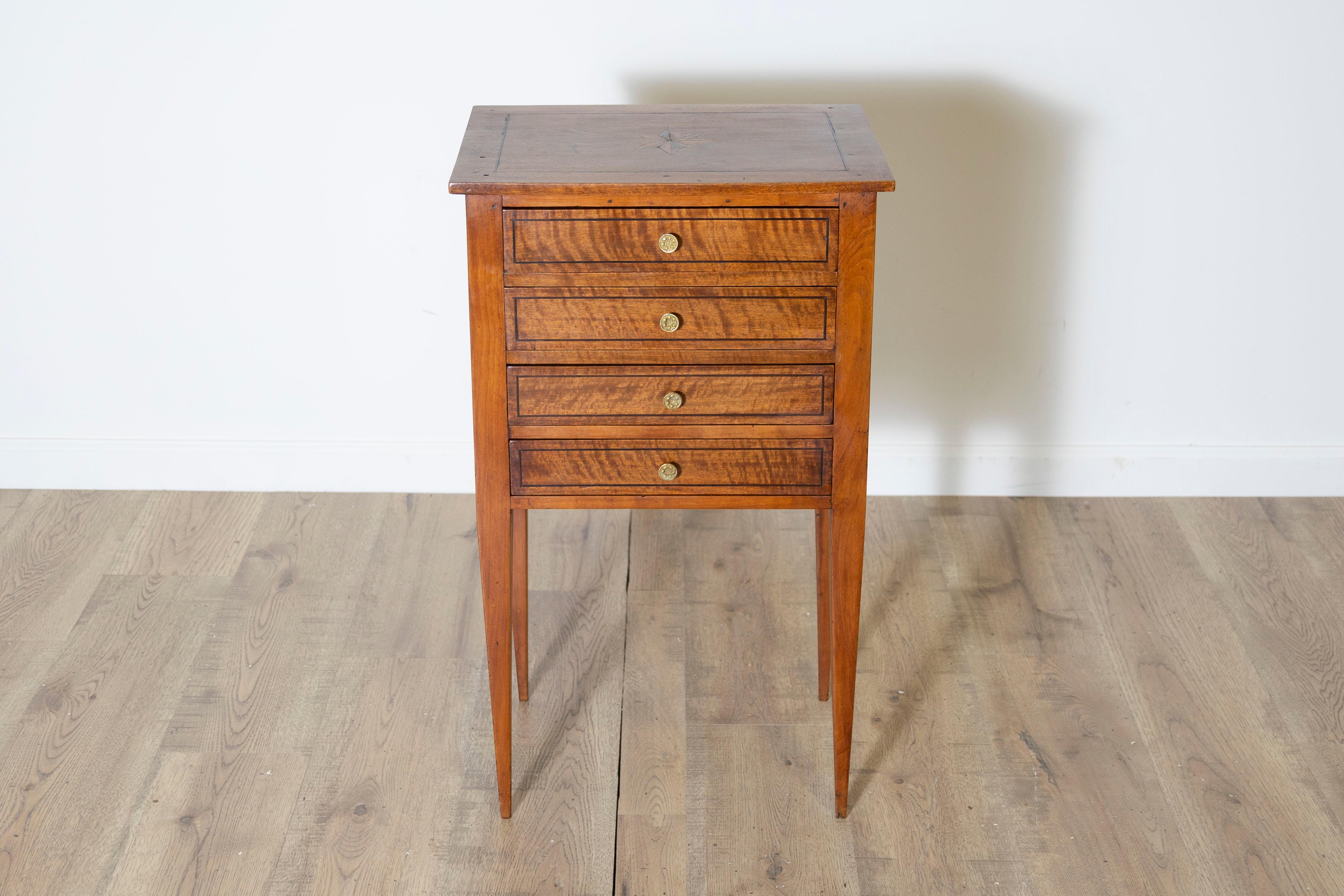A stunning 19th-century Louis XVI-style bedside table crafted from walnut and cherrywood, accented with fine dark wood inlay. This exceptional piece exemplifies the elegance and precision characteristic of the Louis XVI style, with its harmonious