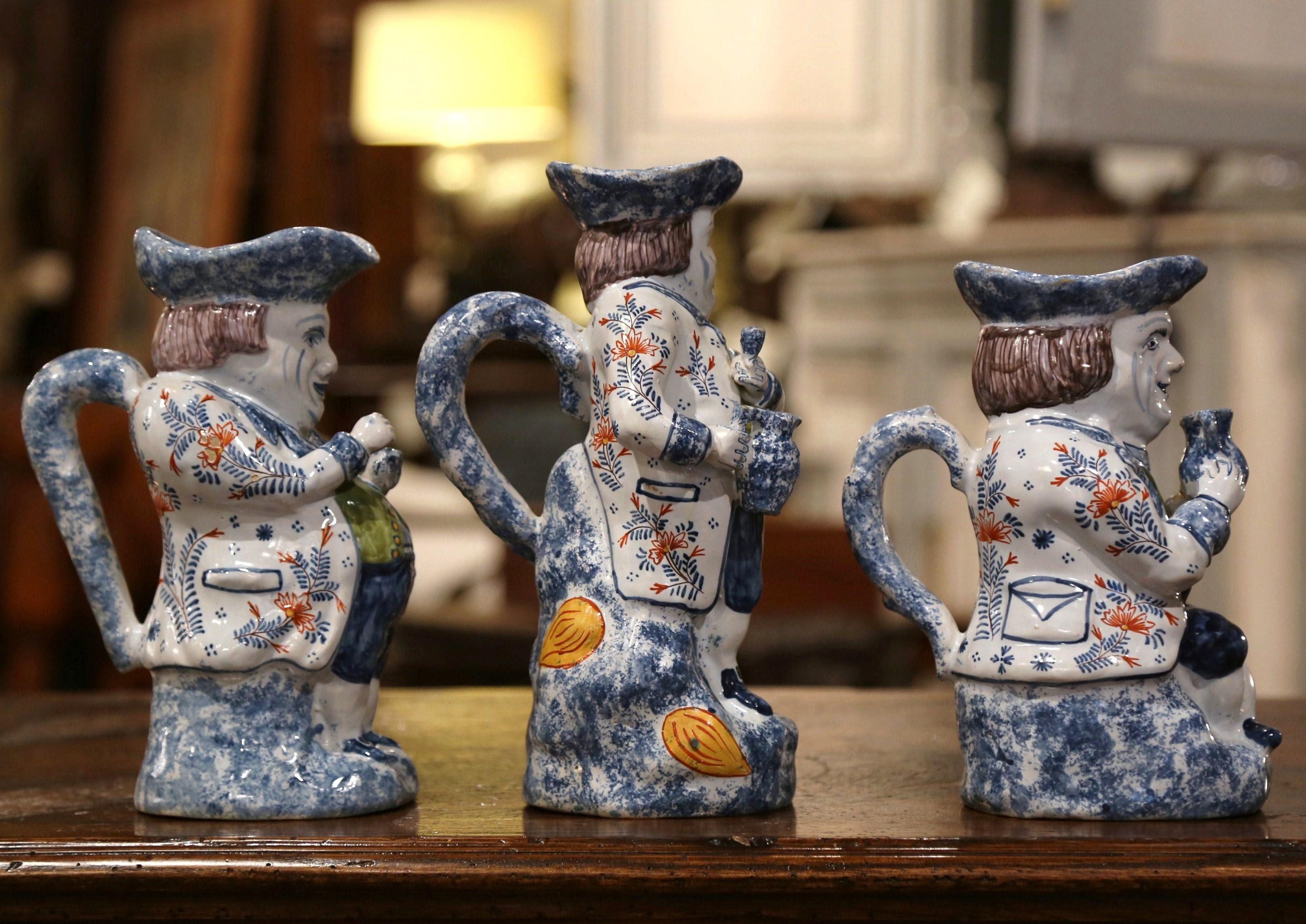 Decorate a wet bar or a shelf with this charming, sculptural Majolica pitchers suite, crafted in Normandy, France circa 1880, each colorful pitcher features a happy man's sculpture dressed in tuxedo and serving wine. The carved pitchers set are hand