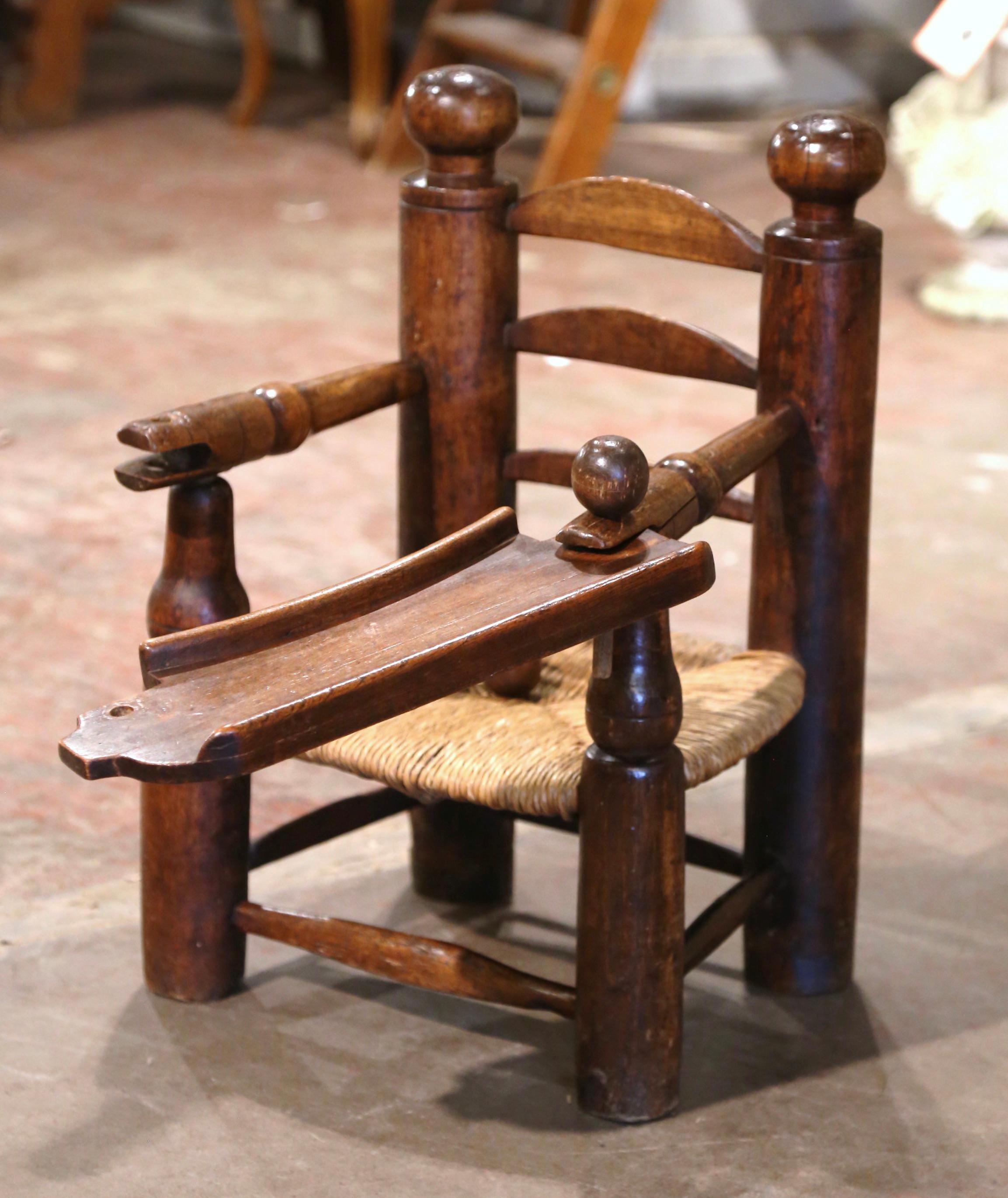 Patinated 19th Century French Normandy Carved Oak Child Feeding Chair with Rush Seat  For Sale