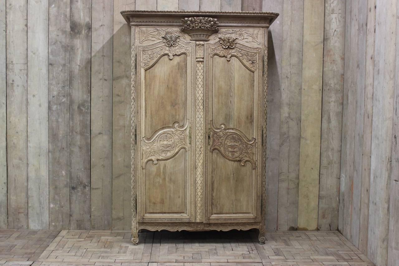 A fine quality, 19th century French marriage armoire in bleached oak with wonderful detail and good proportions. The doors opening to reveal two shelves.