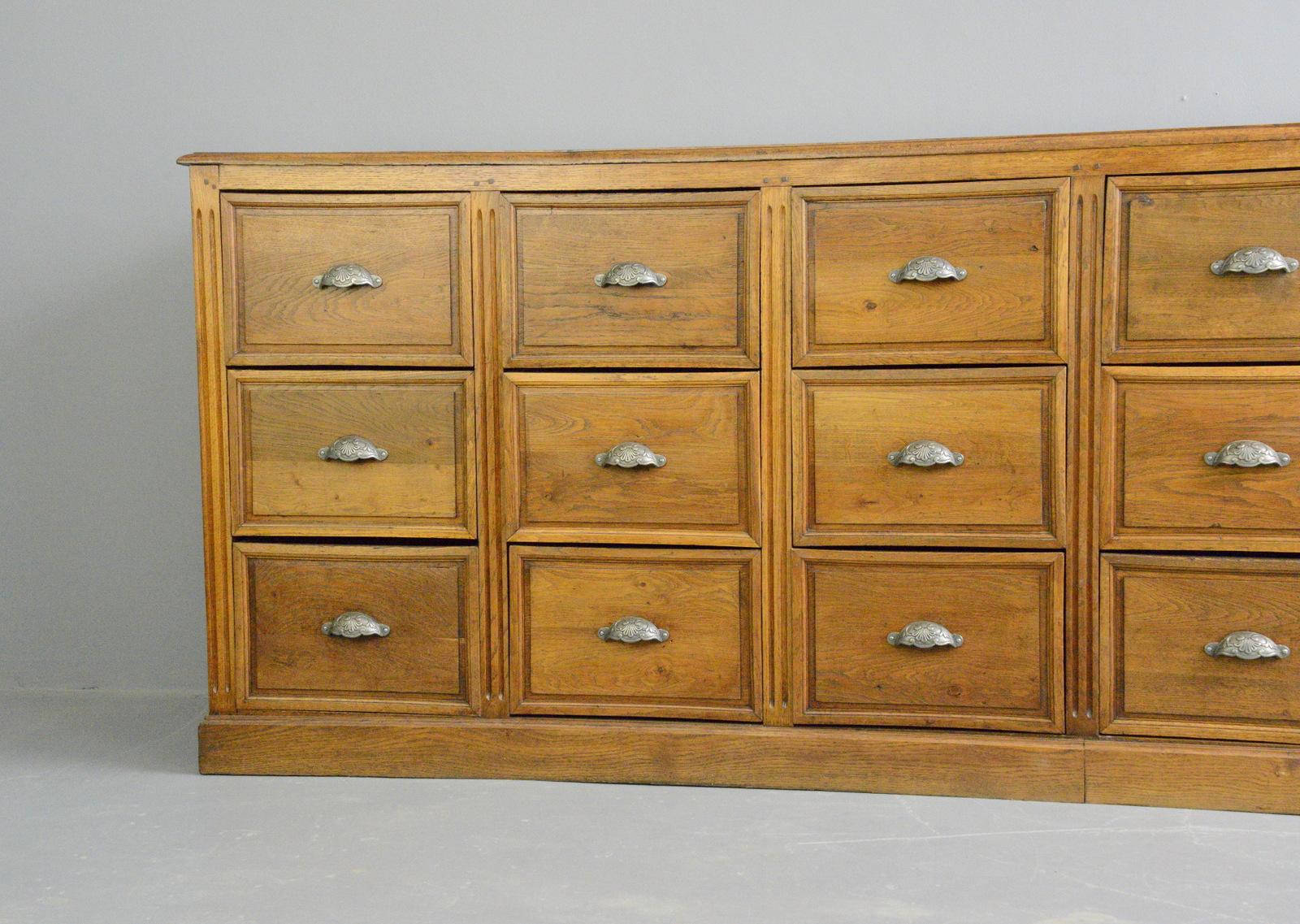 19th century French oak bank of drawers

- Cast iron handles
- Solid oak drawers and frame
- Oak panelled sides
- Solid Oak top
- French, 1890
- Measures: 282cm long x 53cm deep x 102cm tall
- Each drawer measures (internal) 37cm wide x 46cm
