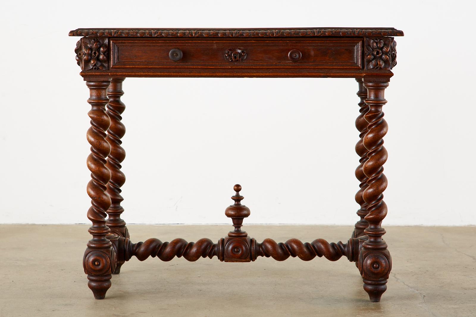Spectacular 19th century French bureau plat writing table or desk featuring barley twist legs and stretcher. Crafted from oak in the grand Louis XIII style fronted by a large 27 inch storage drawer with round pulls. The case of the desk features