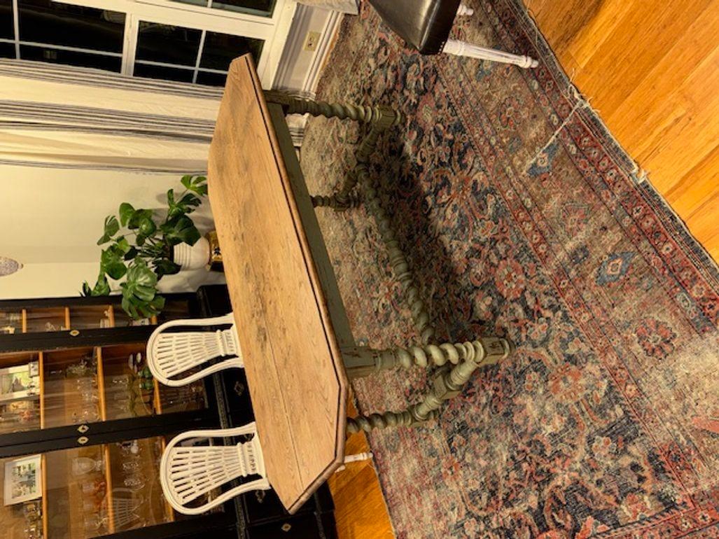 The 19th Century French Oak Barley Twist Dining Table is a beautiful antique piece of furniture featuring a unique Barley Twist design. Made in France, this dining table exudes a classic French style with intricate detailing. The table is crafted