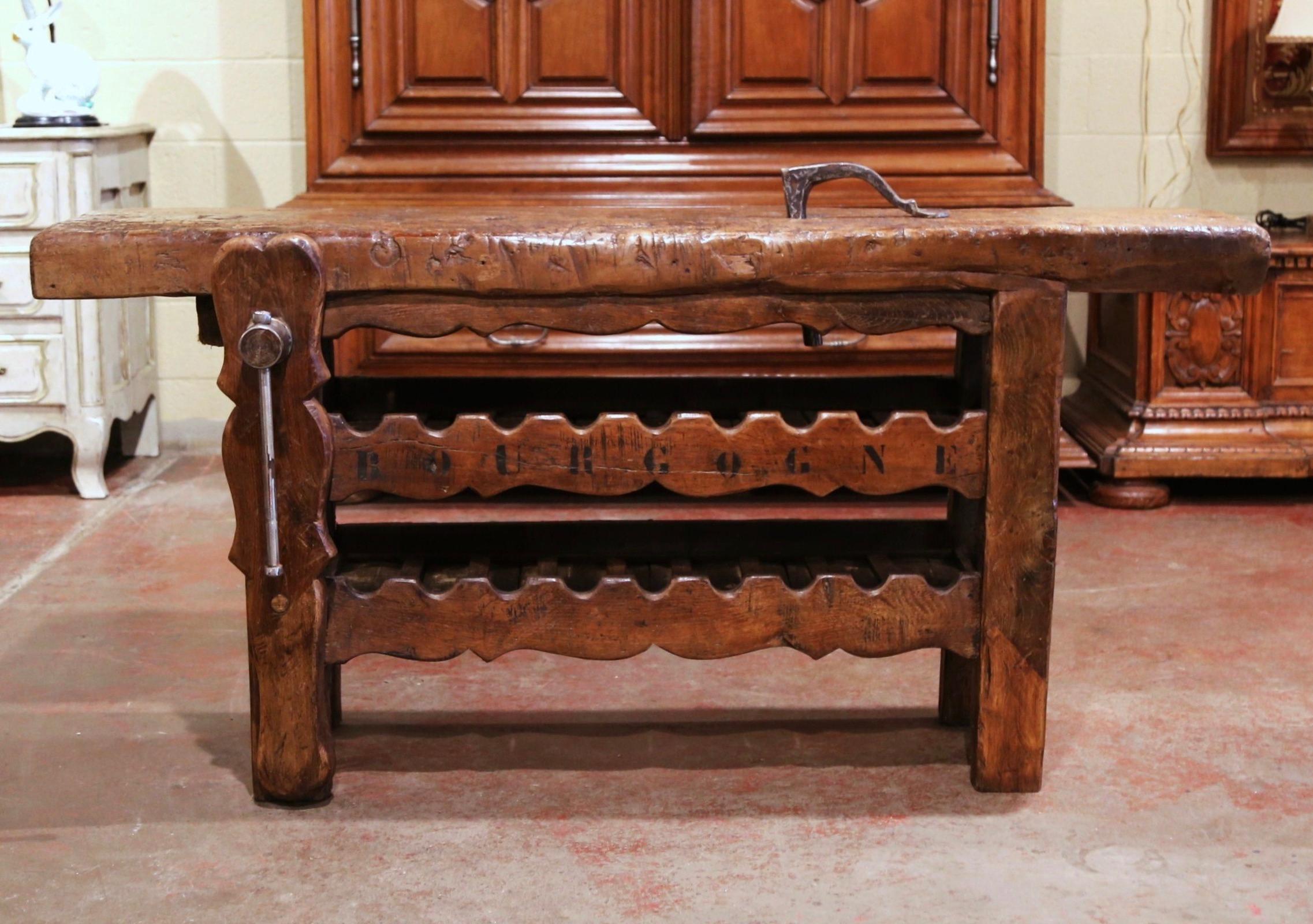 This antique table was crafted in the Poitou region of France, circa 1880. The rustic, oak piece stands on four square legs over a scalloped apron; it has the original plank press mechanism with iron screw and handle attached to one leg. The long