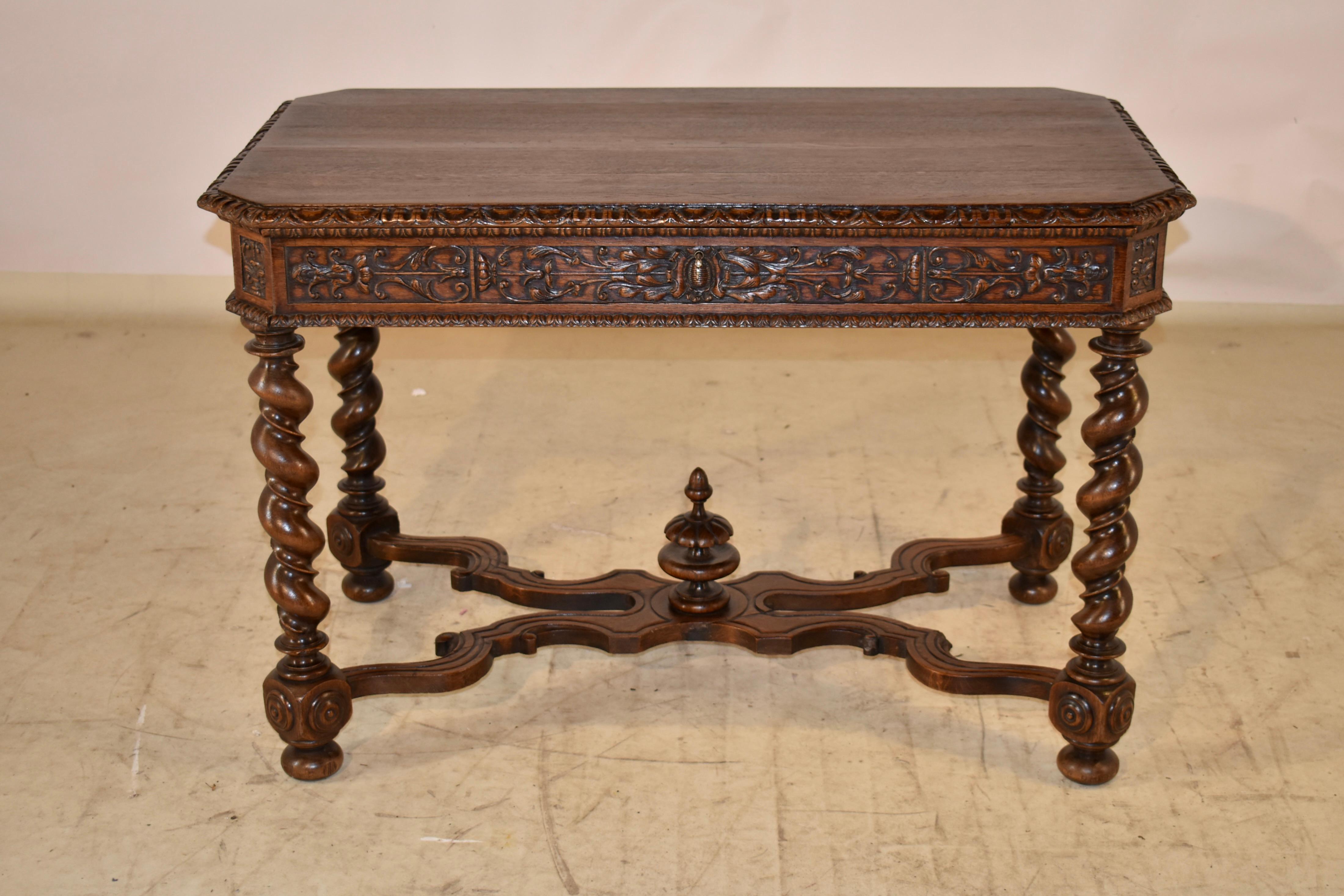 19th century oak side table from France.  The top of this piece is nicely grained and has a beveled and carved decorated edge, following down to a hand carved apron on all four sides for easy placement in any room.  The table has a single drawer in