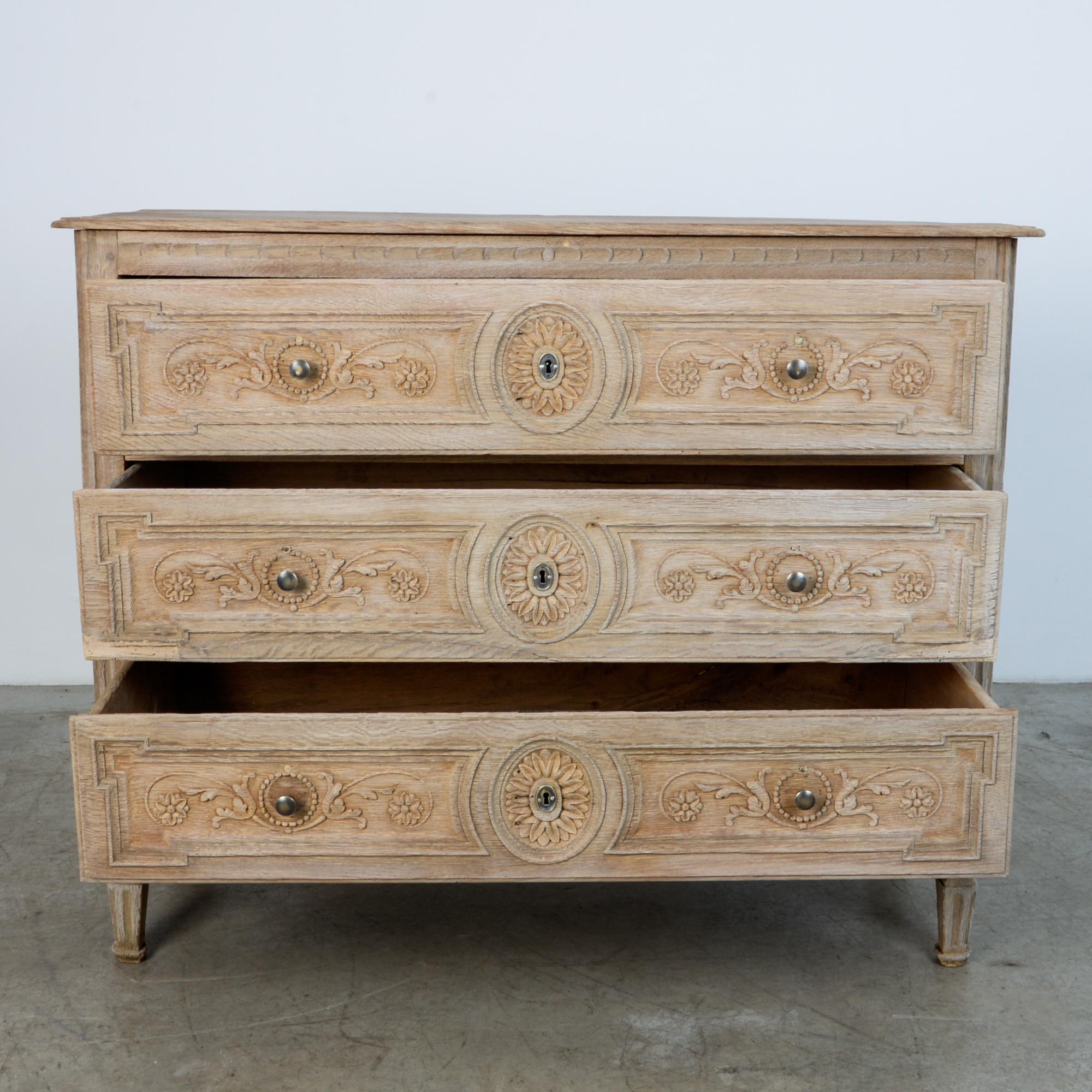 A Louis Philippe style chest of drawers, circa mid-19th century France. Great flower ornament emphasises the original brass locking hardware sealing spacious deep drawers. Underlined by distinctive geometric ornamental apron.

A celebration of