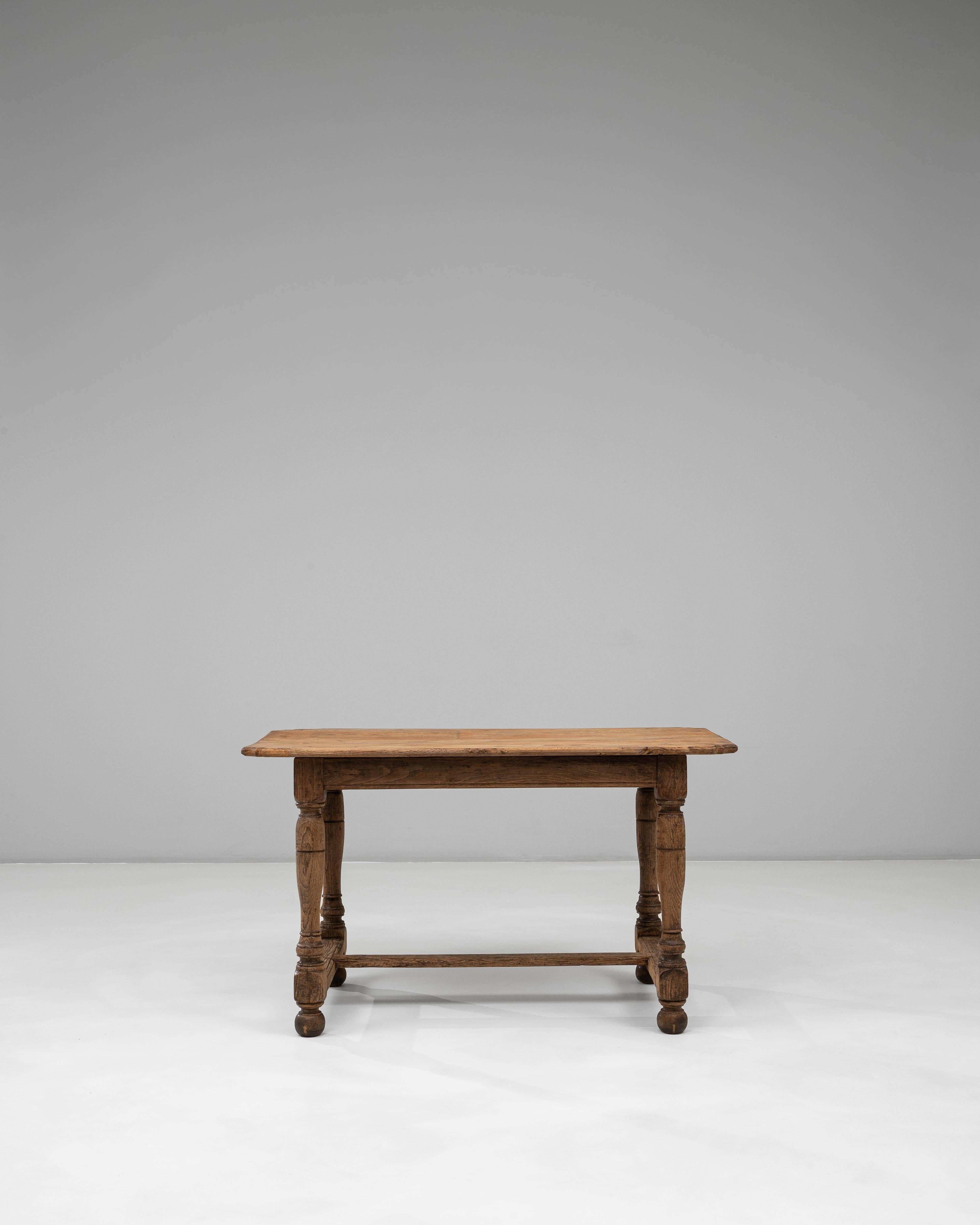Esta mesa de comedor de roble francés del siglo XIX ofrece el discreto encanto y la durabilidad característicos de la artesanía provincial. La encimera rectangular, moldeada por años de uso, muestra una superficie bellamente desgastada con una