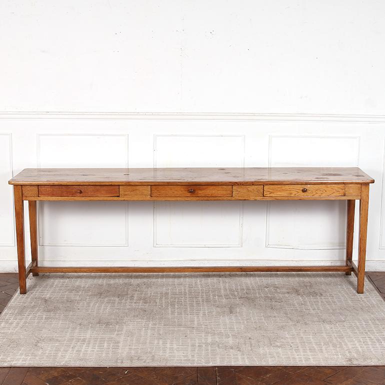 This rare and beautiful, 19th Century, French, Oak drapers table features wide grain detailing with a deep, warm patina. Beautifully hand-built frame with peg and dowelled joints, chamfered legs, and a cross stretcher. The table top has great warmth