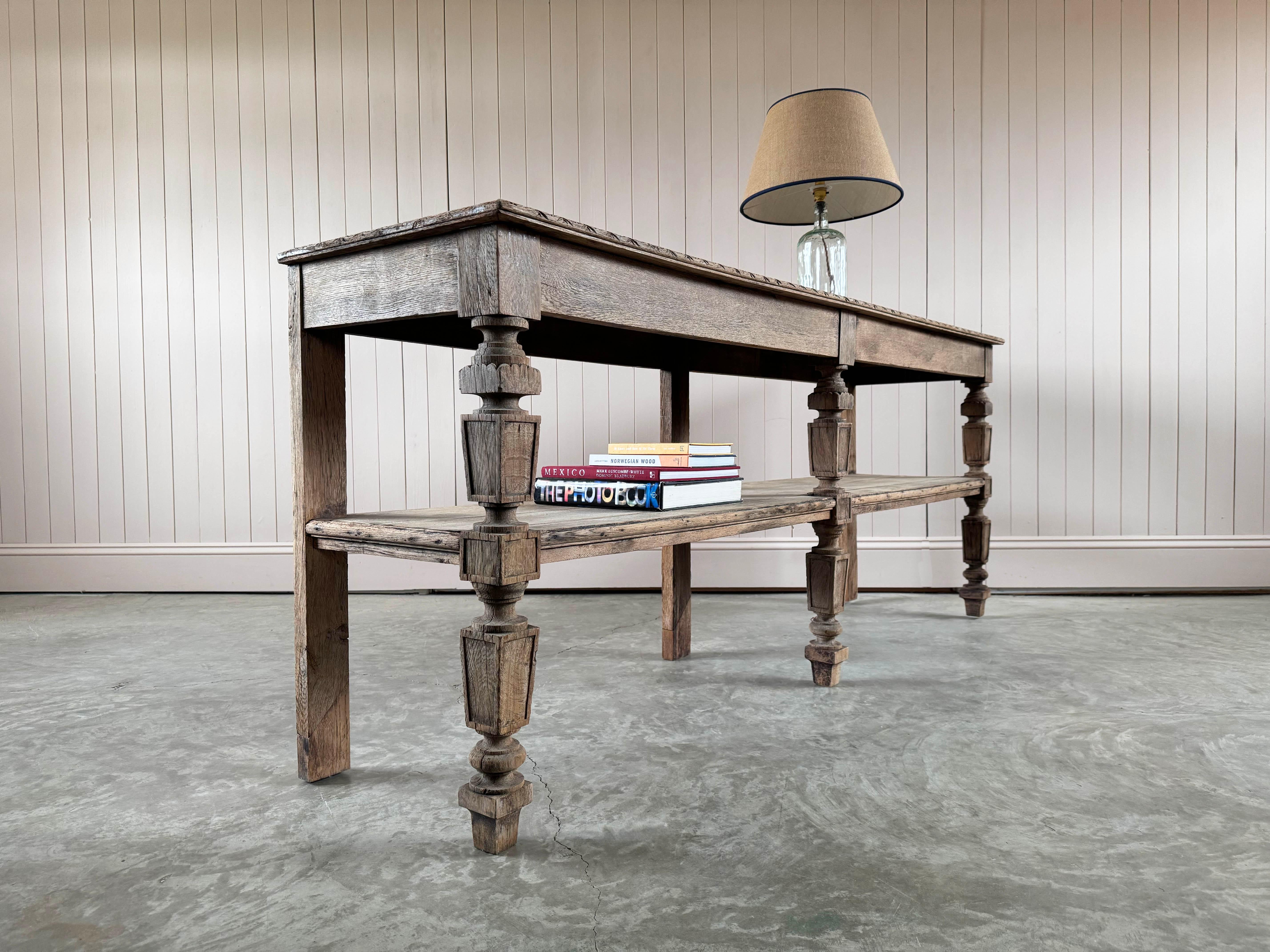 We sourced this unusual antique drapers table from the French / Swiss border.

Made from Oak with a lovely carved detail along the top edge and more decorative carvings on the legs.  Great colour and patina and a useful size. This would look lovely