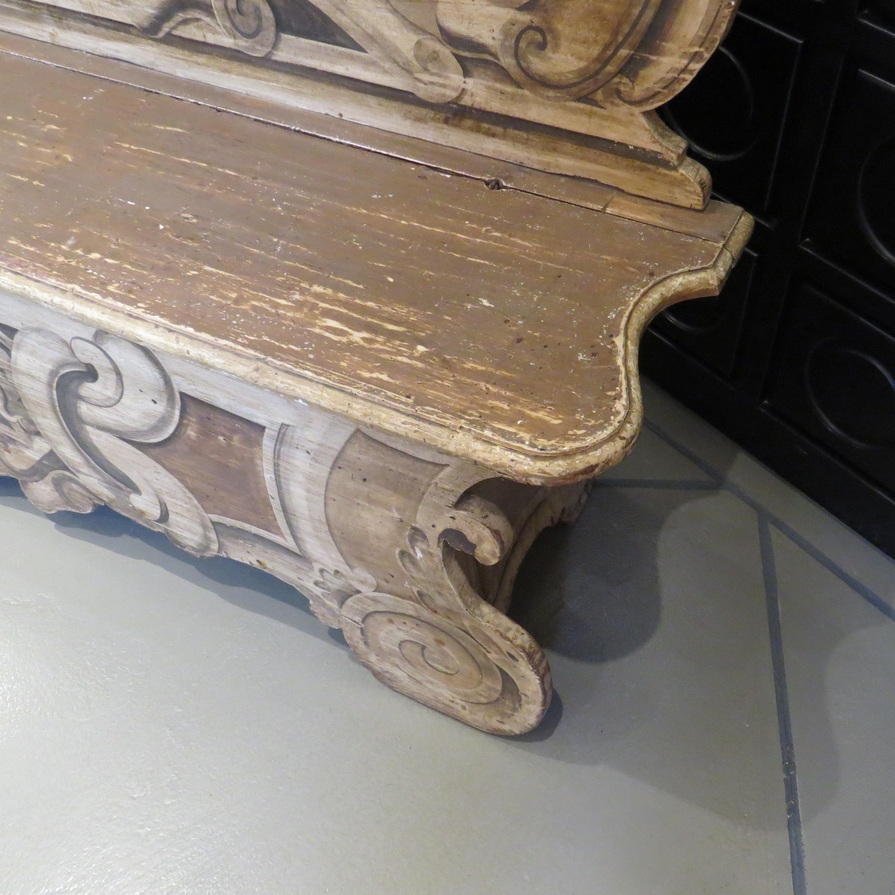 The tall shaped back of the Venetian style bench is hand-painted in gold, tan and charcoal colors. It is made of French oak and has a locking lid on the seat.