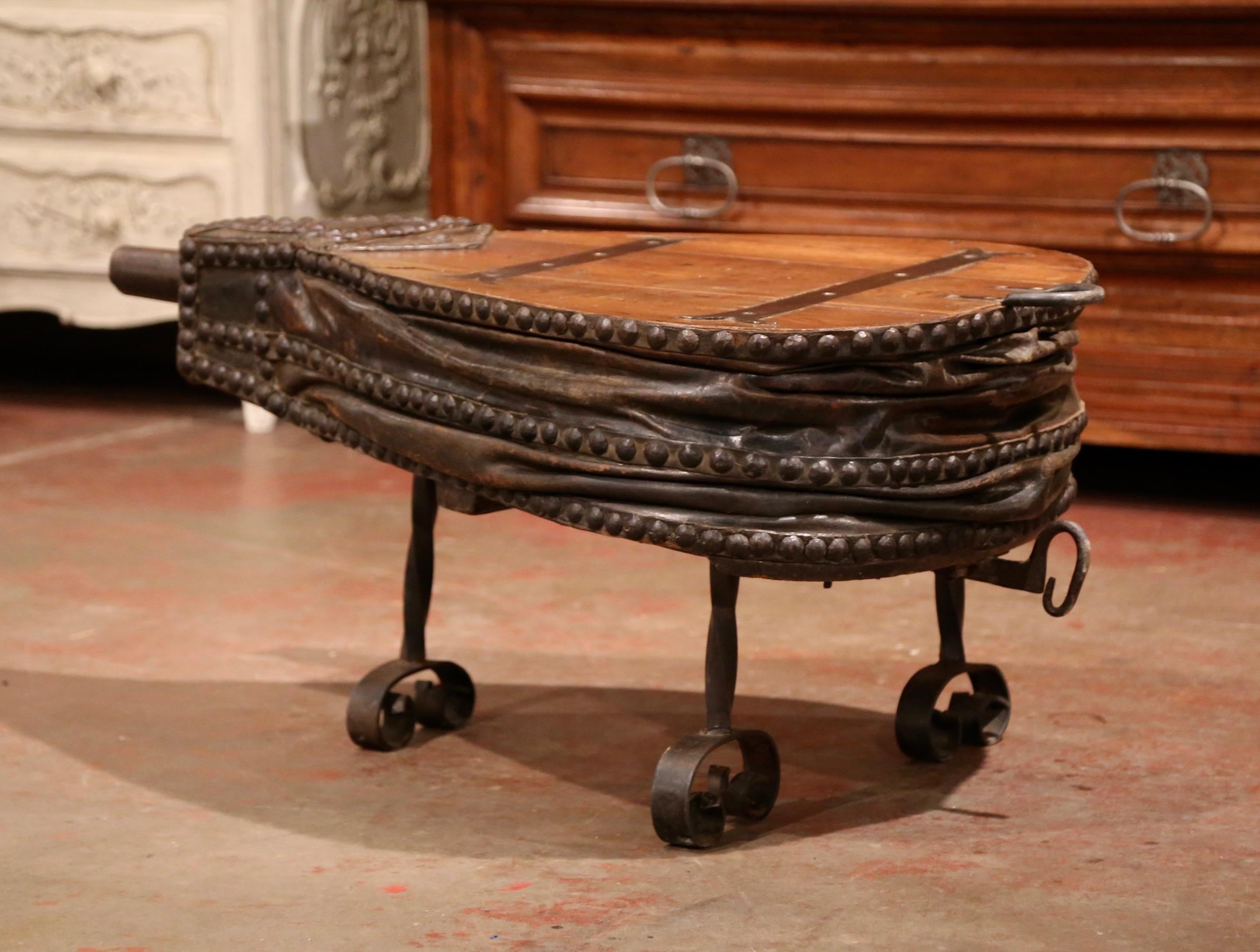 Decorate a ranch or a country living room with this unusual antique blacksmith's bellows coffee table. Crafted in France circa 1860 and shaped as a heart, the table stands on three intricate iron legs. The piece features the original accordion