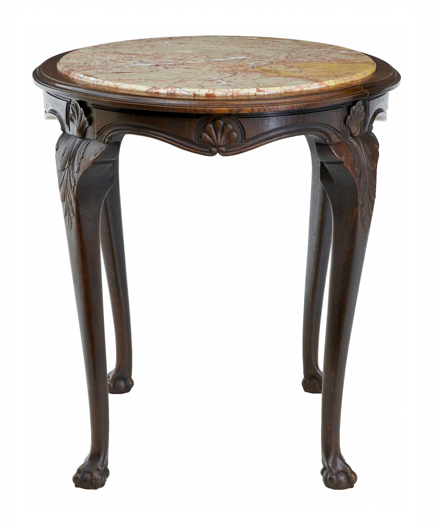 19th century French oak marble top center table circa 1880.

Art Nouveau oak center table, stunning inset veined marble top with carved shells to the apron. Standing on 4 cabriole legs with further shells and carved leaves. Terminating on a ball