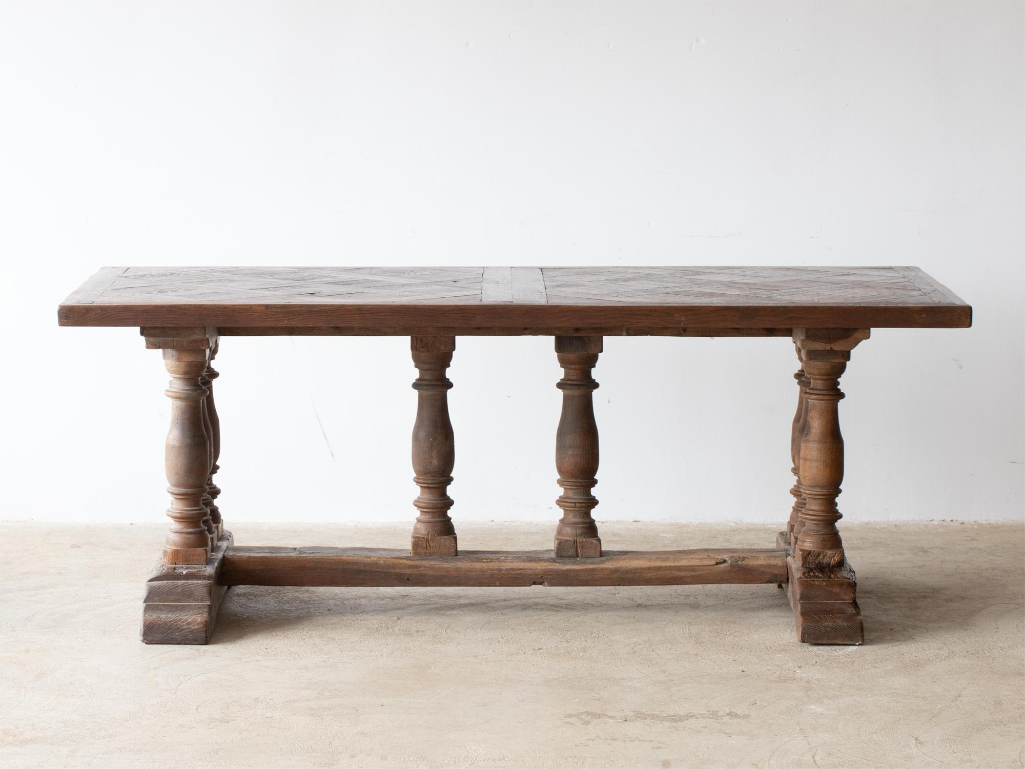 A monumental oak refectory dining table. French, 19C.

Stock ref. #2299

Removable oak parquetry top raised on eight turned columns.

In good sturdy order with characterful wear. Traces of historic worm all treated as a precautionary and
