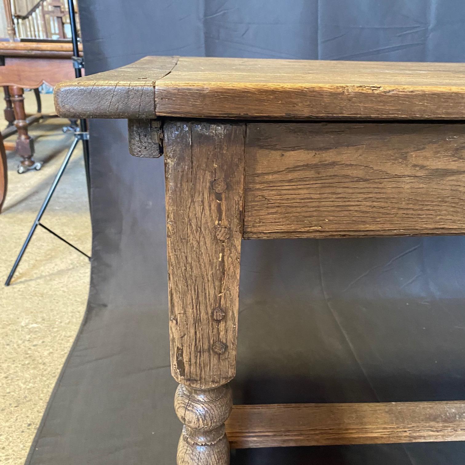 A rare find in this 19th century French oak farmhouse refectory table. A very architecturally pleasing design raised on hand turned legs united by a central stretcher. Displaying a really beautiful and rich patina throughout. The top slides over to