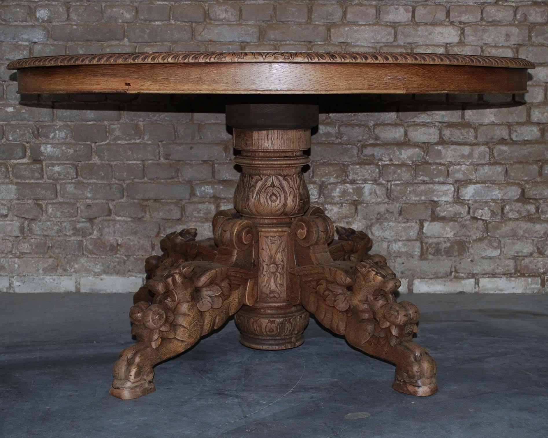 This 19th century French Renaissance oval hunt table was sculpted from solid oak and features elaborately carved winged foxes beautifully rendered on the scrolled legs below. Support is provided by a large carved urn style pediment at the center.