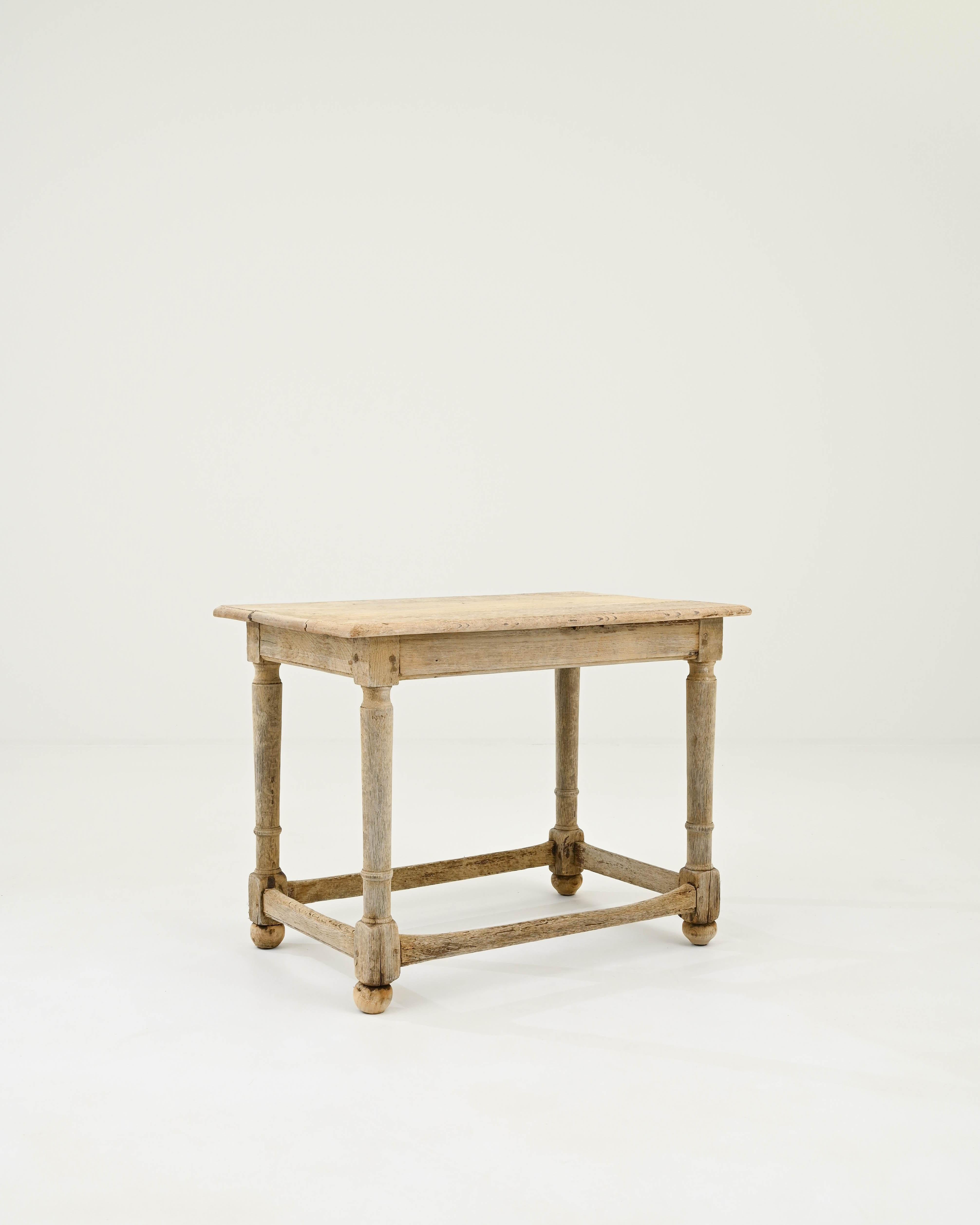 A wooden side table created in 19th century France. Rusticly simple, this farmhouse style side table projects an invitingly cheery glow. With lovingly lathed and carved legs, dowel peg connections, and mortise and tenon joinery,  traditional