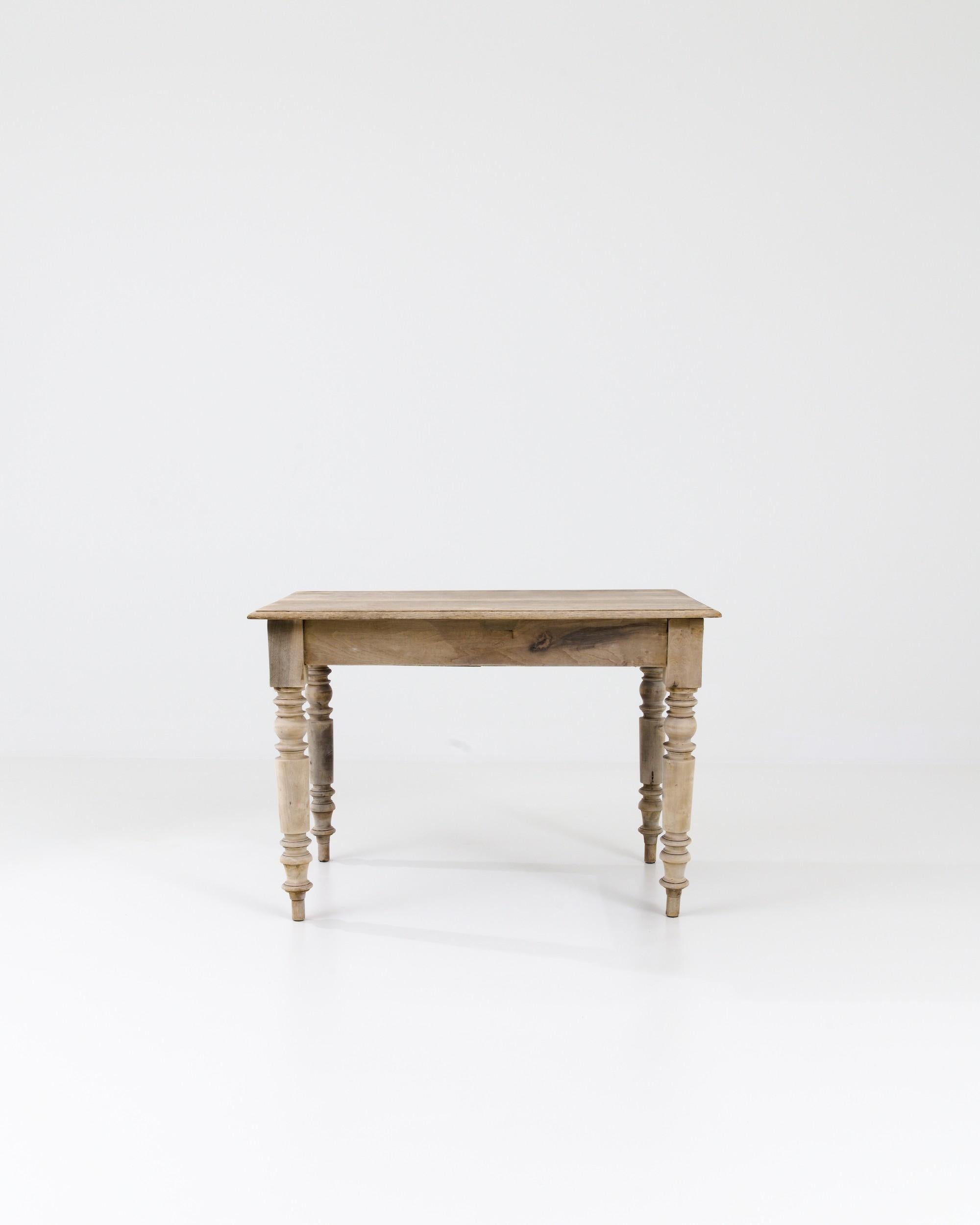 A eye-catching silhouette and a warm organic finish make this antique oak side table a find to treasure. Hand-made in France in the 1800s, turned legs create a strikingly elaborate profile, creating a flamboyant contrast with the simple tabletop.