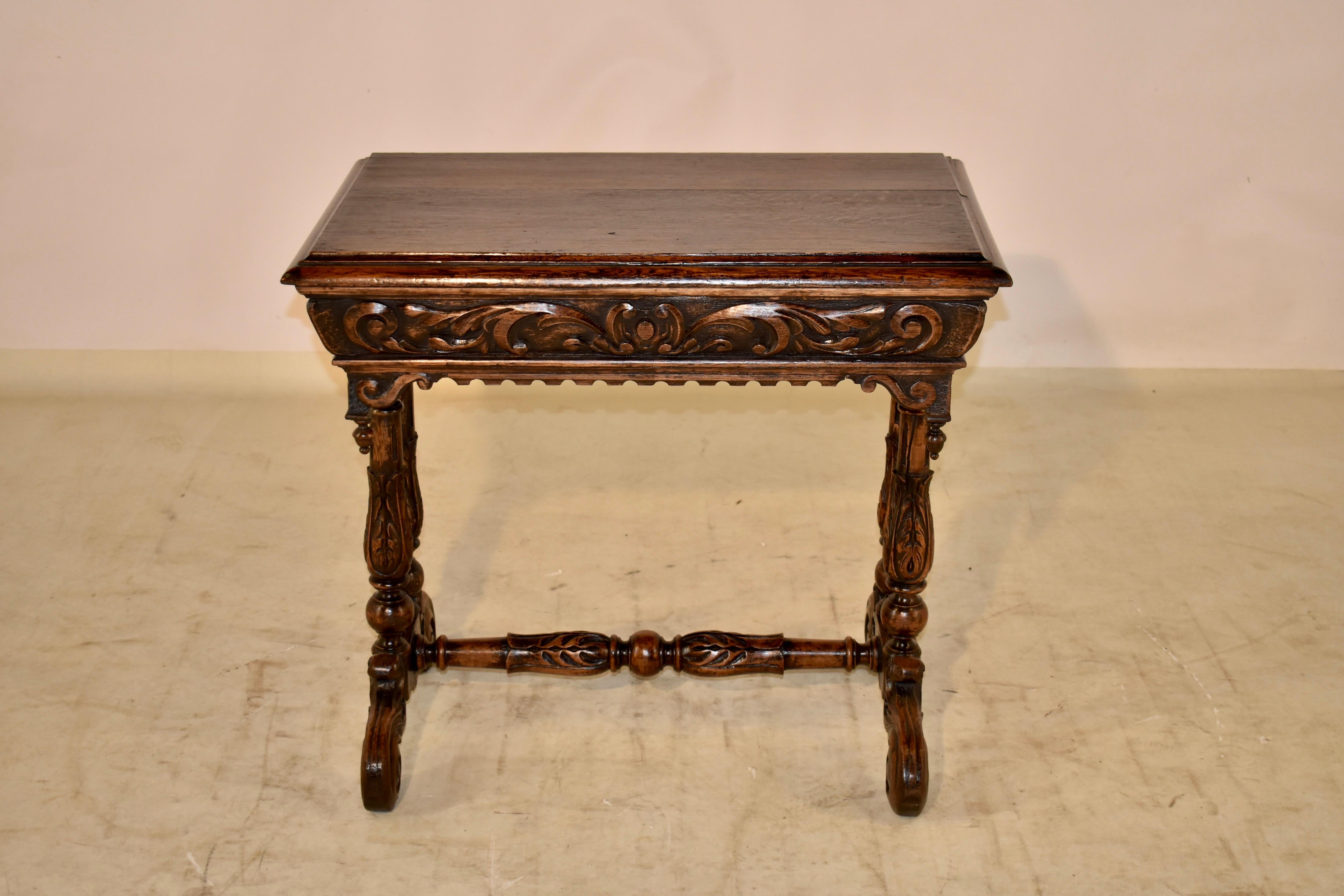 19th century oak side table from France.  The top has a stacked beveled edge, and follows down to a carved apron on all four sides, for easy placement in any room.  There is a scalloped and hand turned finial decoration on the sides as well.  The