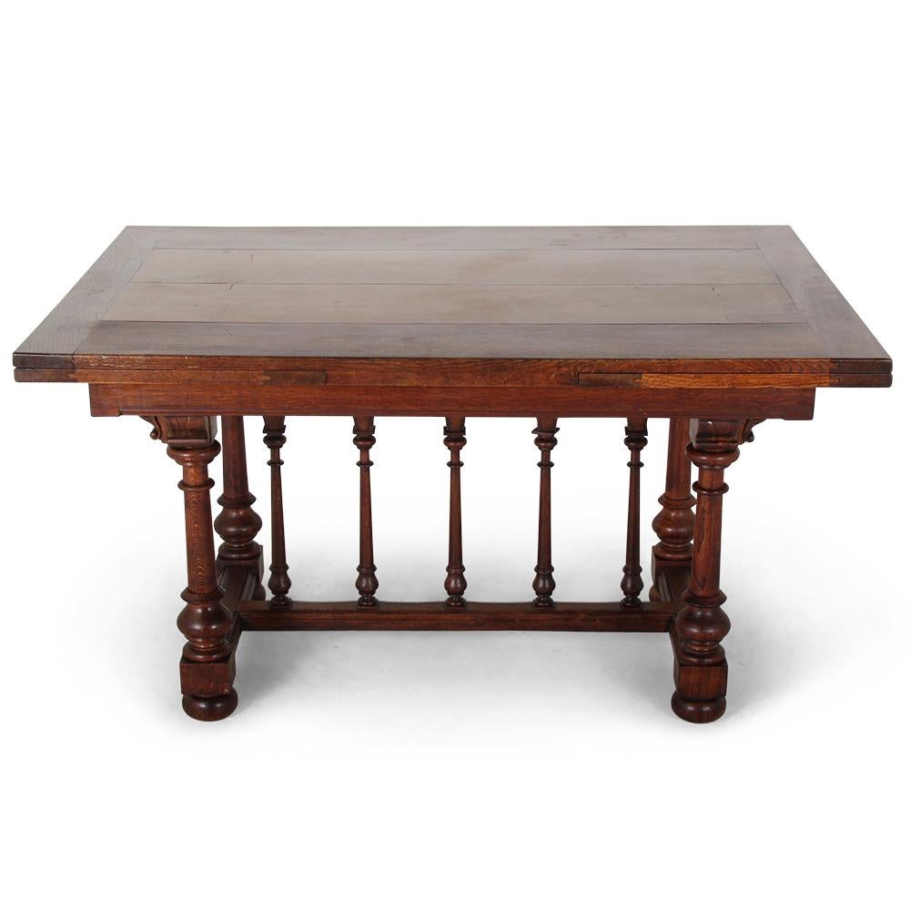 A late 19th century French solid oak 'draw-leaf' dining table, the base with unusual Moorish or Middle-Eastern influenced carving, arches, and columns.
The table is sturdy and suitable for everyday use and the leaves pull-out smoothly.
We have