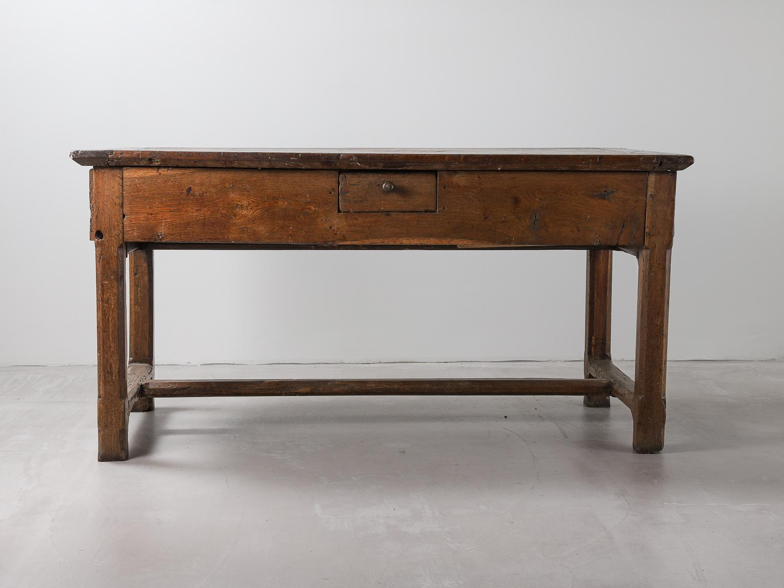 19th century French oak table with centre stretcher. Each end and drawer. Slight wear to the stretchers and top, consistent to the period.