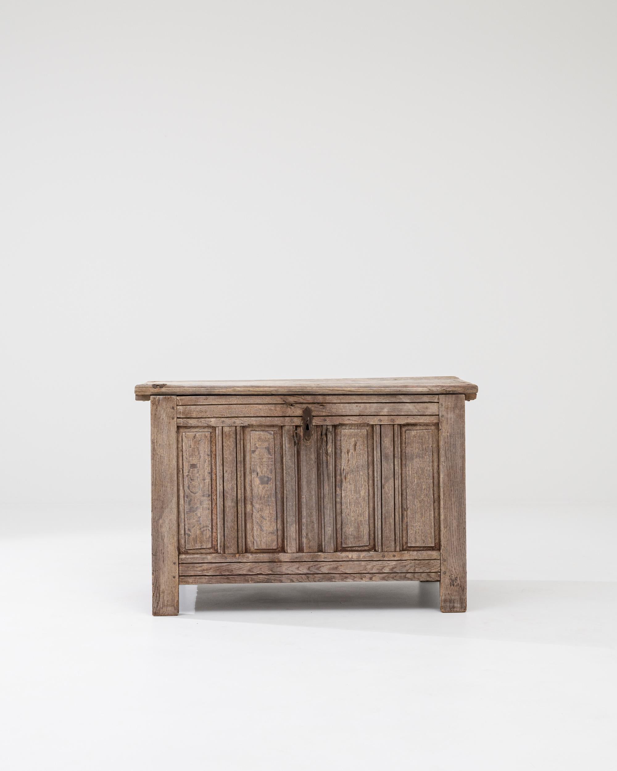 Simple and statuesque, this antique wooden chest possesses a romantic charm. Made in France in the 1800s, the form is inspired by the gothic chests of the middle ages: a simple silhouette that evokes a bygone age of castles and chivalry. The lid