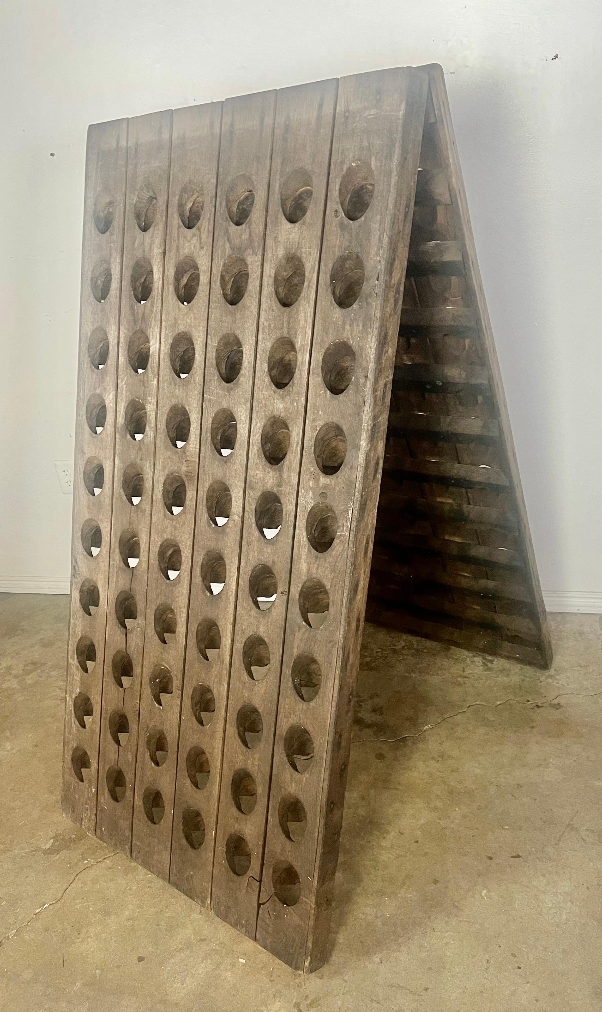 Unique two sided French wine rack that holds 120 bottles of wine.  From the side it has an adjustable frame depending on your needs.  The oak has been beautifully weathered.
