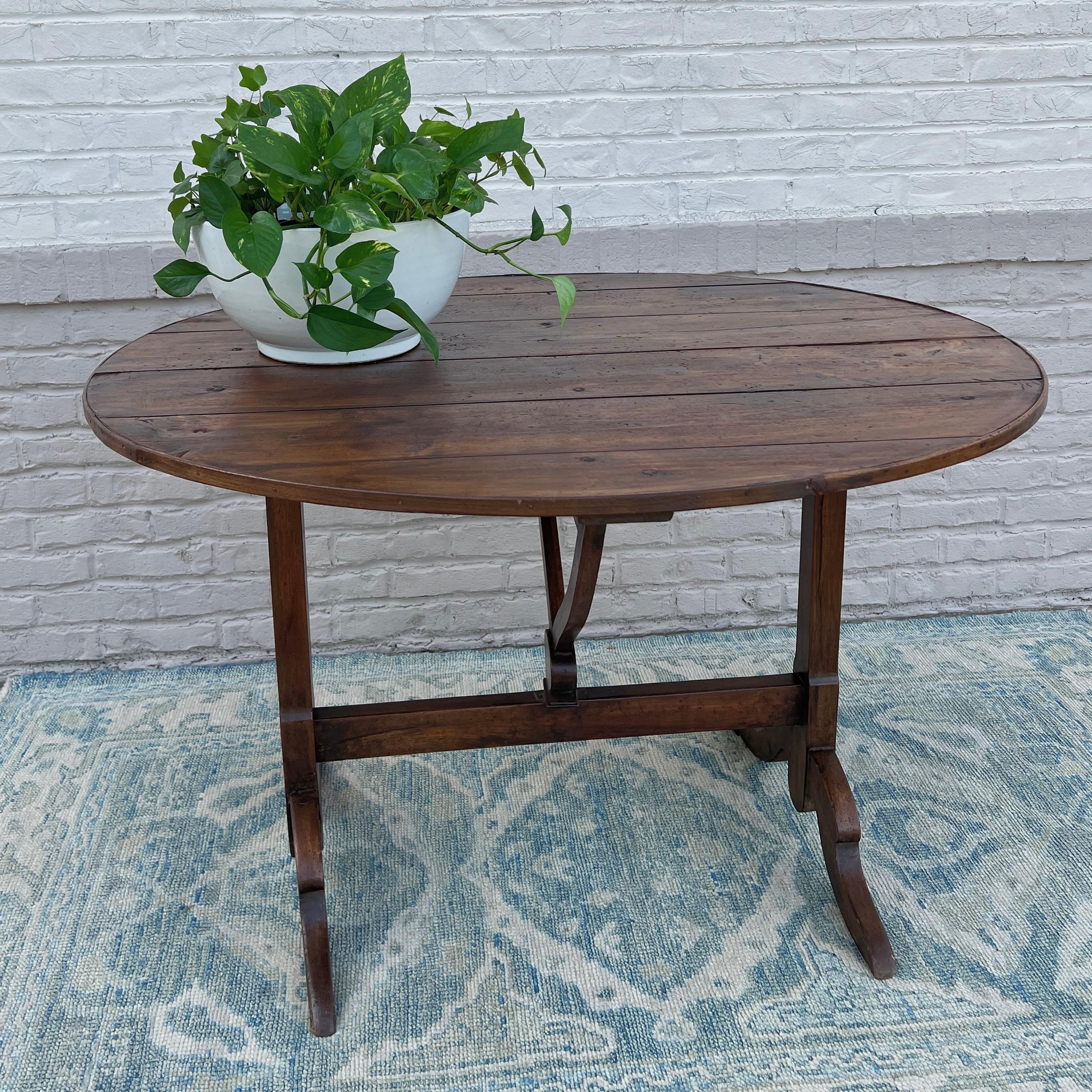circa 19th century France. 

Beautiful oak wine tasting table that was once used in the vineyards of France for tasting wine or enjoying a meal. Featuring a tilt top with a banded edge and a truly gorgeous patina that has been restored with a