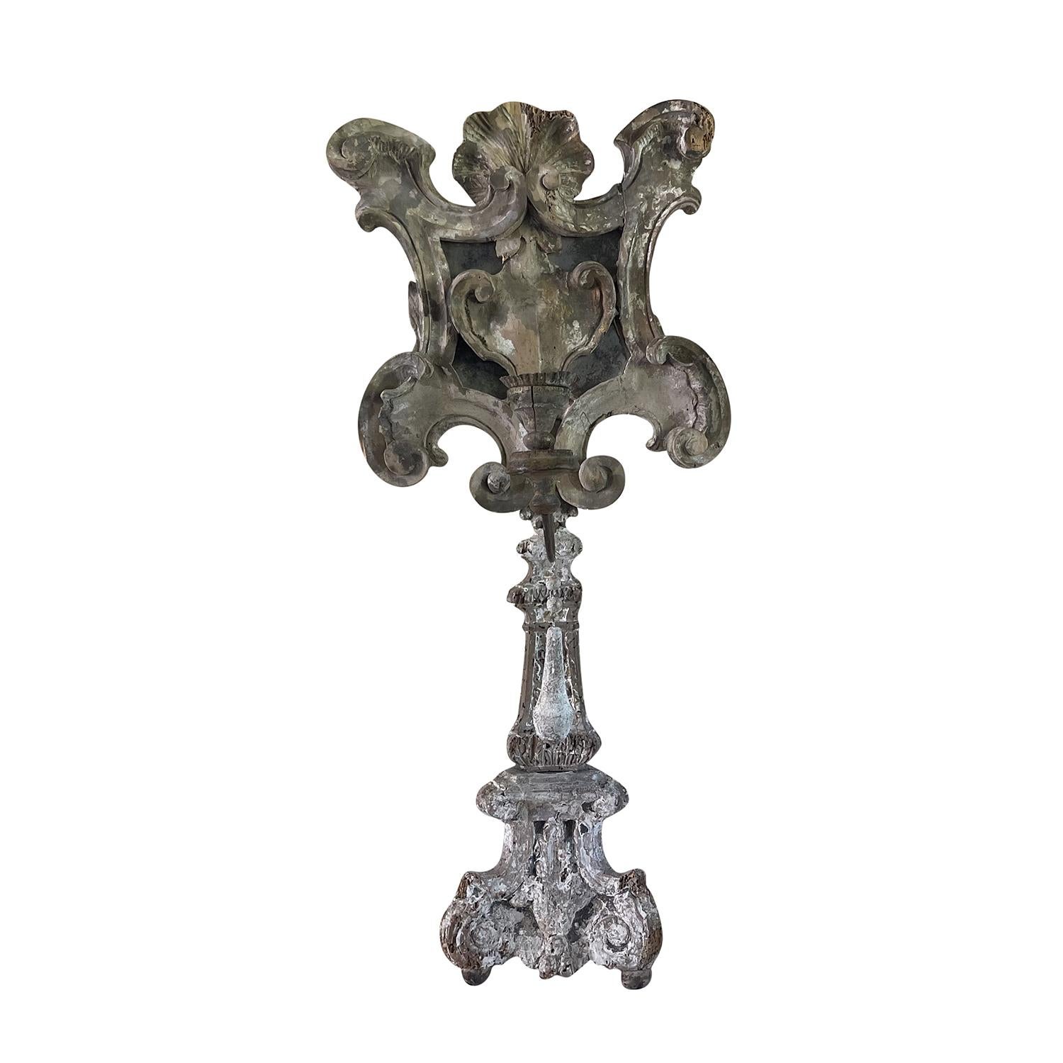 An antique French candle holder made of hand crafted in Oakwood with small mirror inserts and a candle holder with plate, in good condition. This decorative interior ornament was part of a credenza and has a beautifully weathered patina. Minor