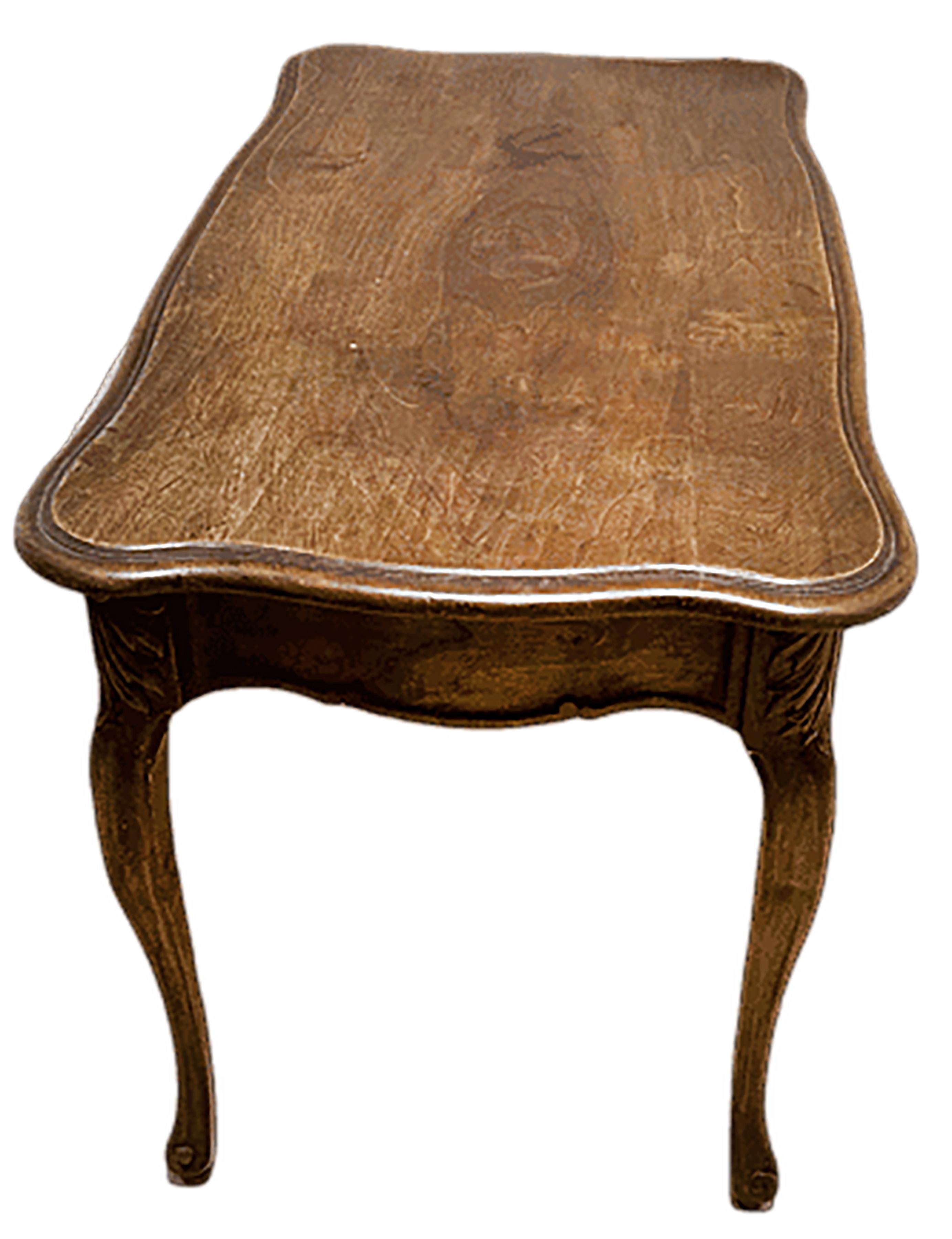 An elegantly simple 19th century French occasional table in the Louis XV style. Hand made with solid wood. Walnut brown finish. The front has a small pullout drawer with a brass handle.

In good condition. Some gentle wear consistent with age and