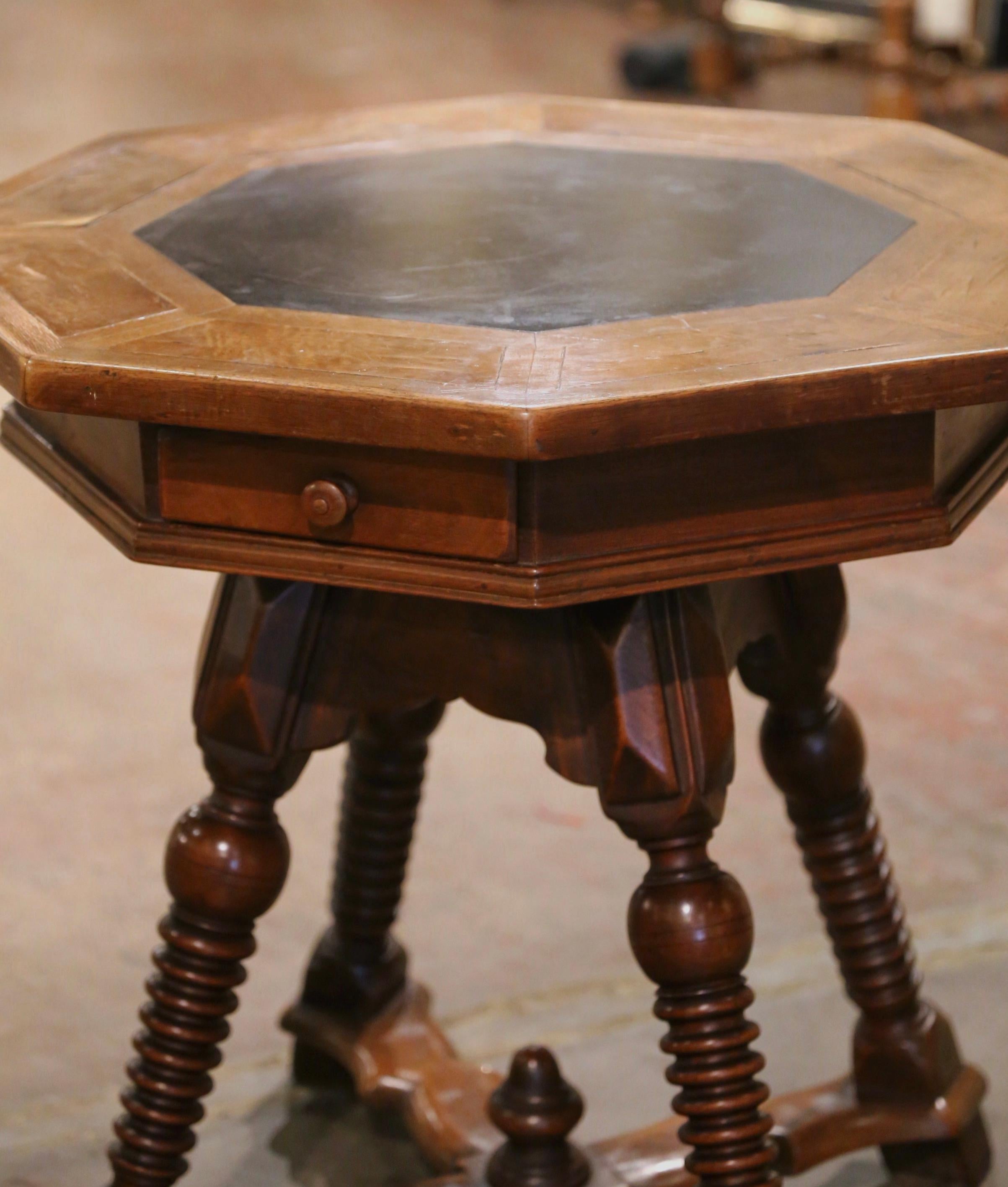 Place this interesting and detailed fruit wood table next to a couch or in a corner. Crafted in France, circa 1880, the antique side table has eight sides, a shaped apron and four turned legs connected with a four-armed stretcher across the bottom