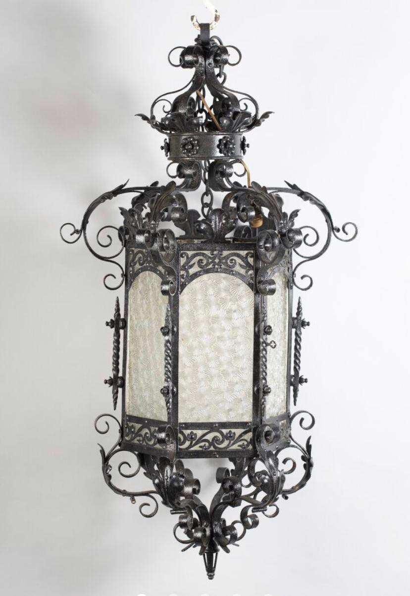 Octagonal lantern in black hand patinated and hand carved iron, in the style of the Renaissance made in France in late 19th century.
The piece is in good authentic condition with only one side piece of glass missing.
 