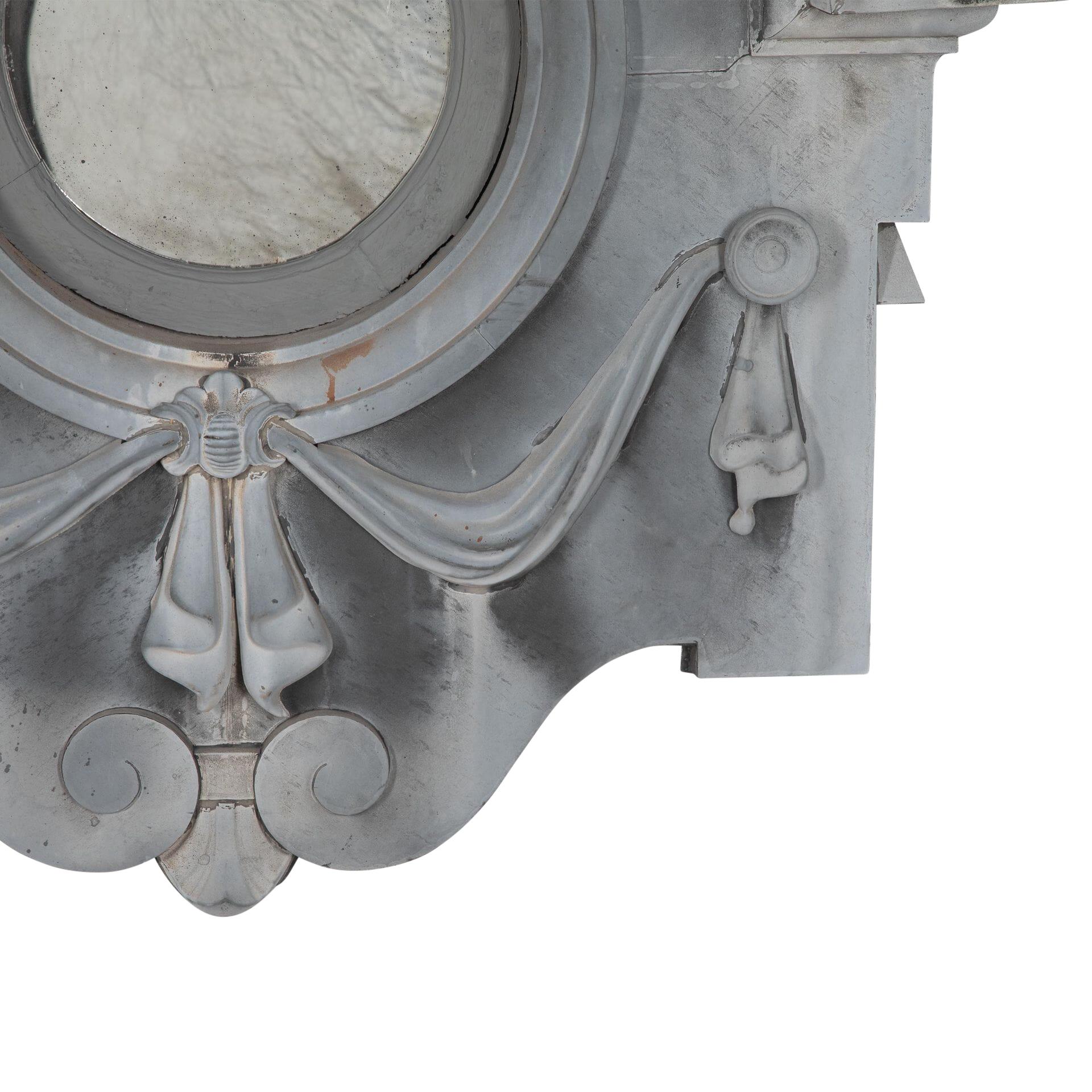 19th century decorative zinc oeil-de-bouef which has been converted into a mirror with a faux mirror plate.