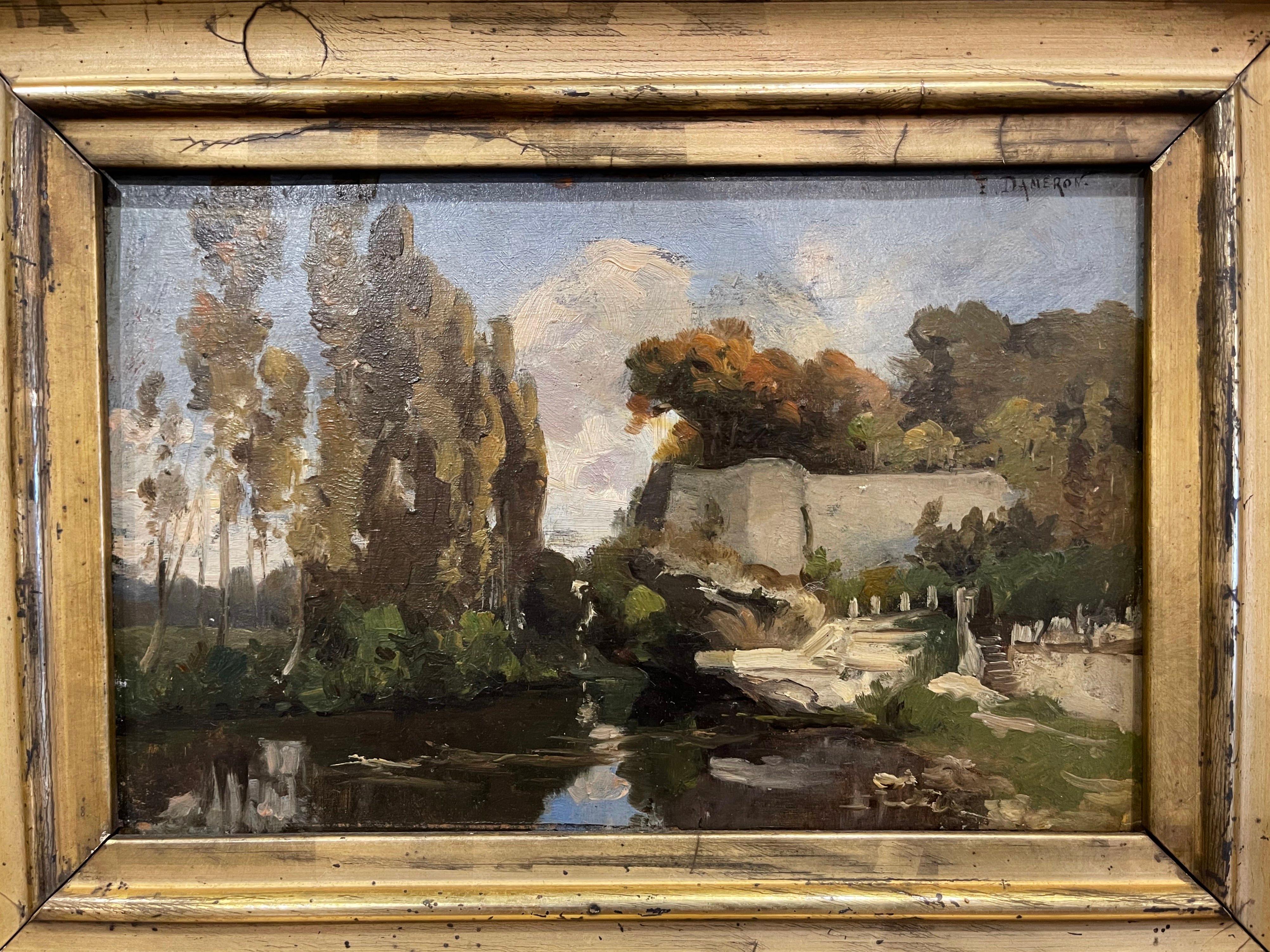 This charming antique Barbizon painting signed Dameron was created in France, circa 1880. Set in the original carved gilt frame, the artwork painted on board depicts a landscape scene with trees and river. The expressive composition is in excellent