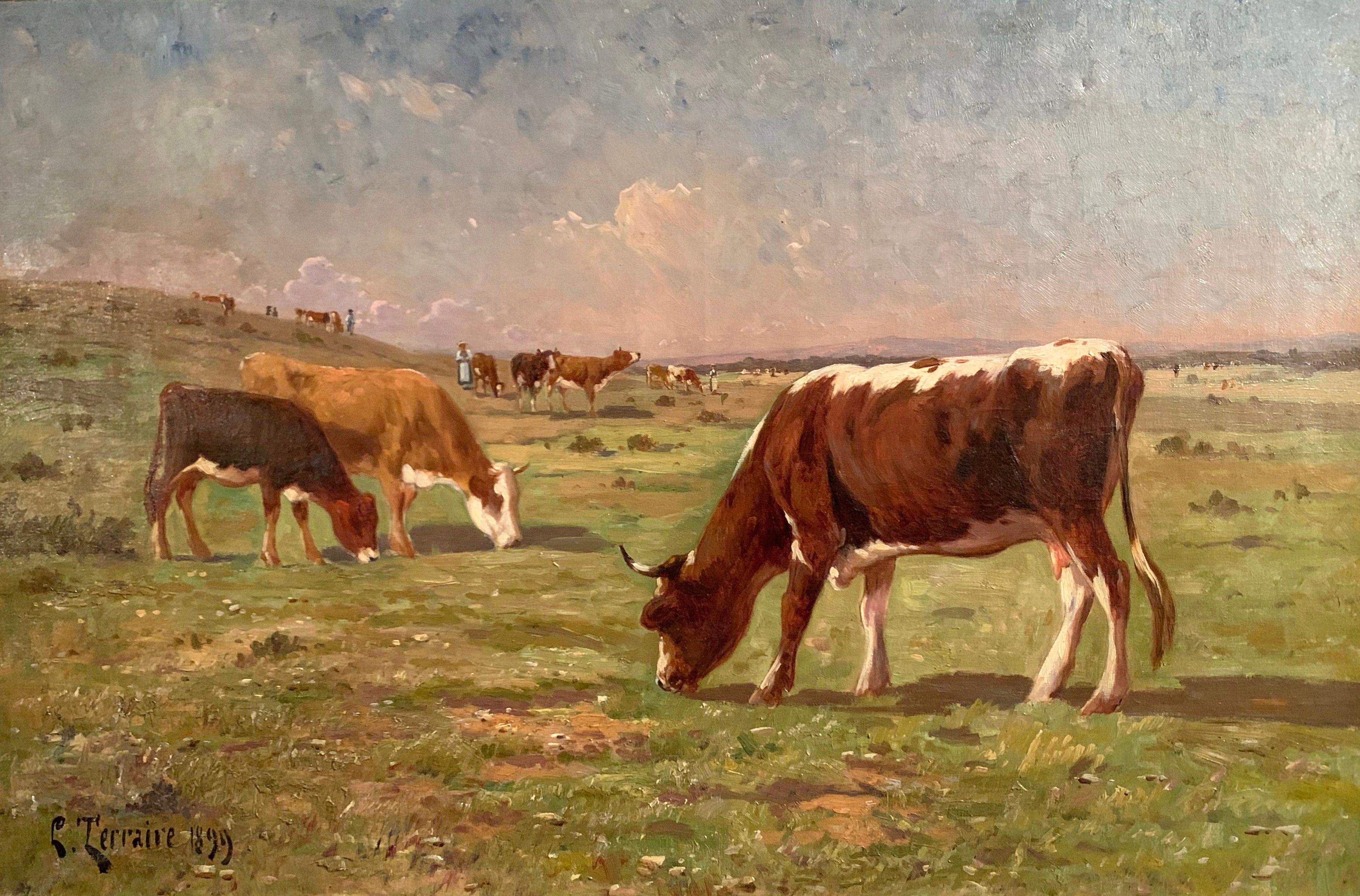 Set in the original gilt wood frame, this painting depicts a pastoral scene with three cows grazing. The colorful canvas is signed and dated in the lower left corner by the artist, C. Terraire, 1899. The painting is in excellent condition with great