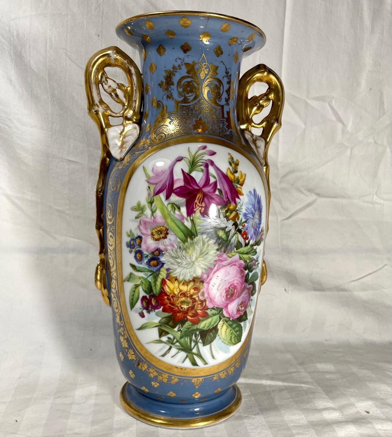 19th century French Old Paris double handled porcelain vase.

Mid 19th century exceptional decorative porcelain vase featuring two gilt handles. The exterior is finely painted with a large floral bouquet in reserve. Gilt decoration on a blue