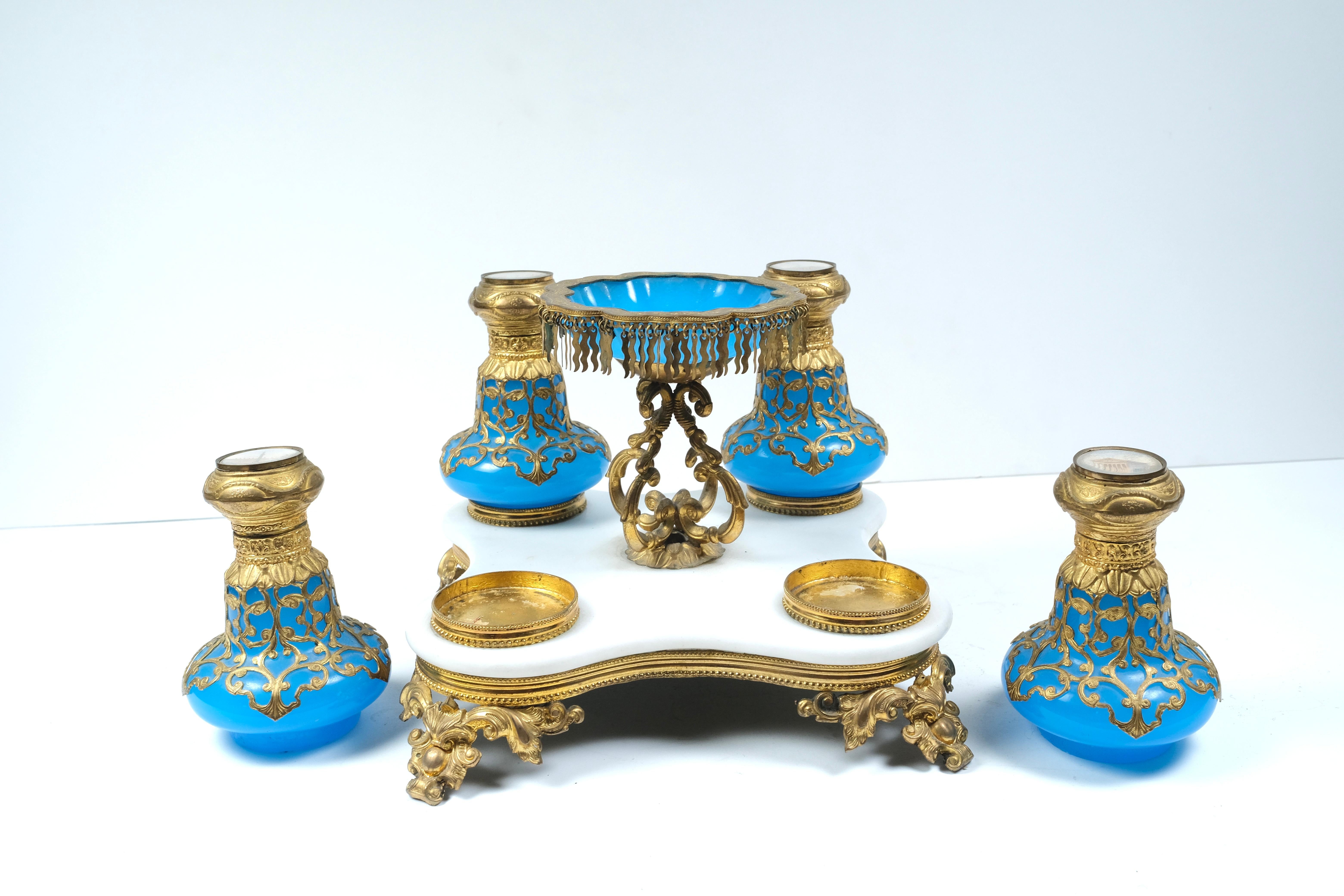 Rare. Dore bronze mounted opaline bottles with hand painted scenes. Bronze-mounted marble stand with ring dish. Very unusual.