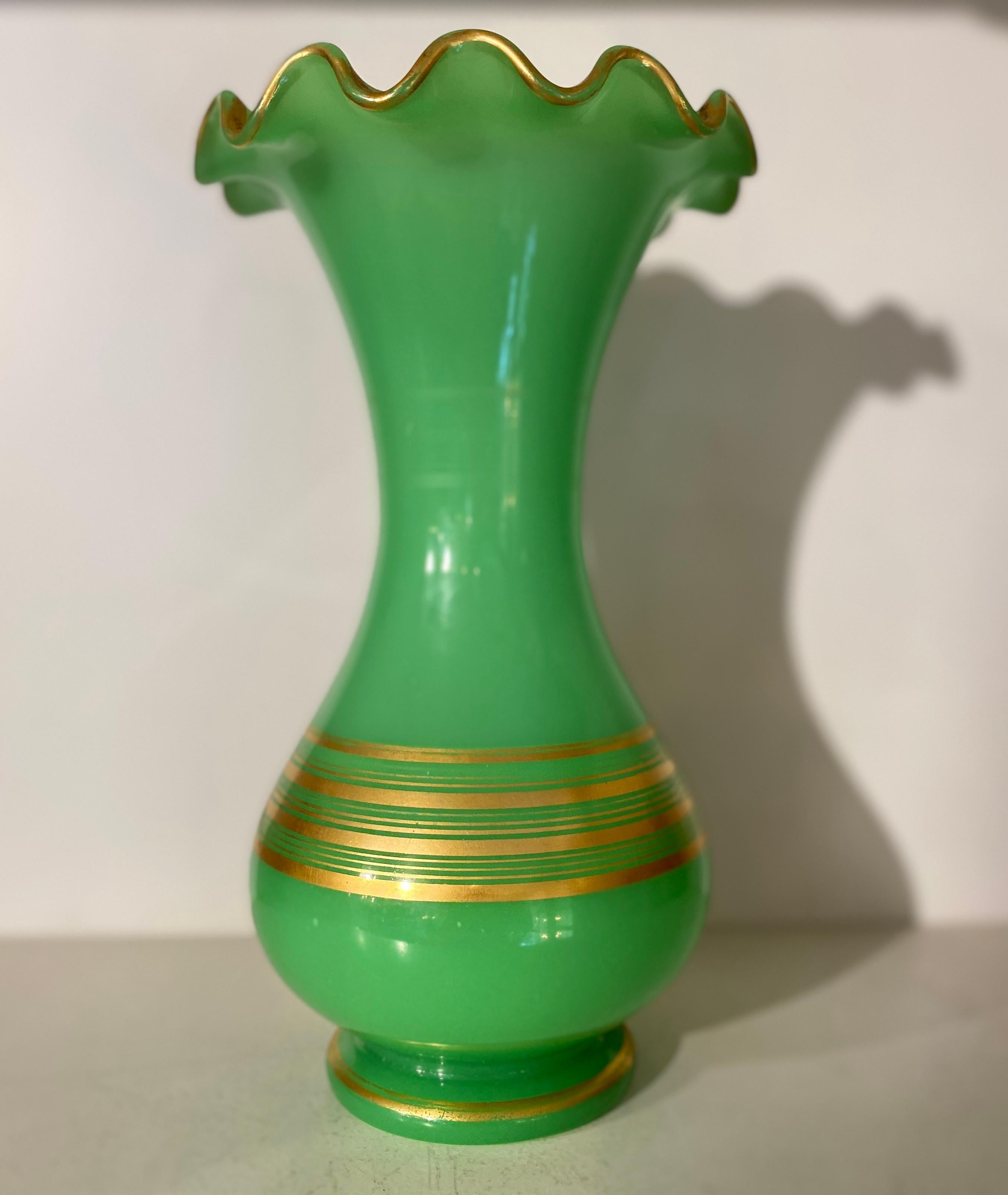 A 19th-century French opaline uranium glass vase is a charming and collectible glassware piece crafted in France during the 1800s. These vases are characterized by their opalescent, milky appearance and a unique greenish glow when exposed to